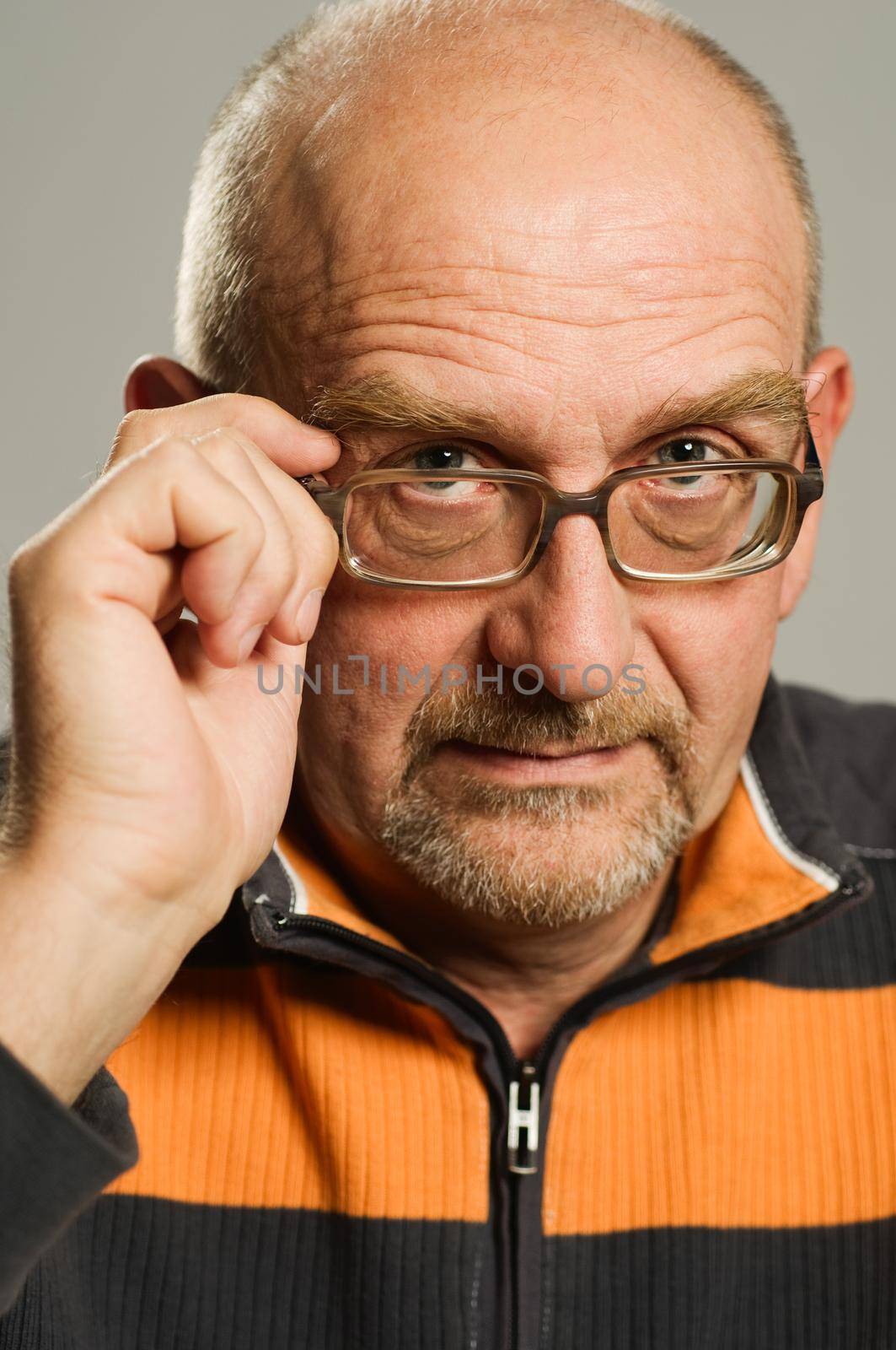 Handsome mature man posing on plain background