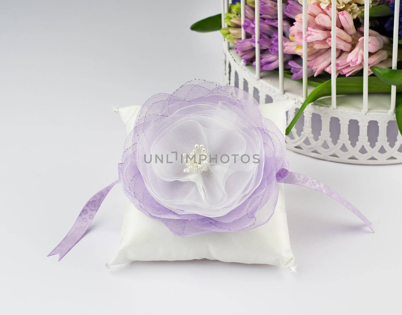 Exquisite pillow for wedding rings on gray background