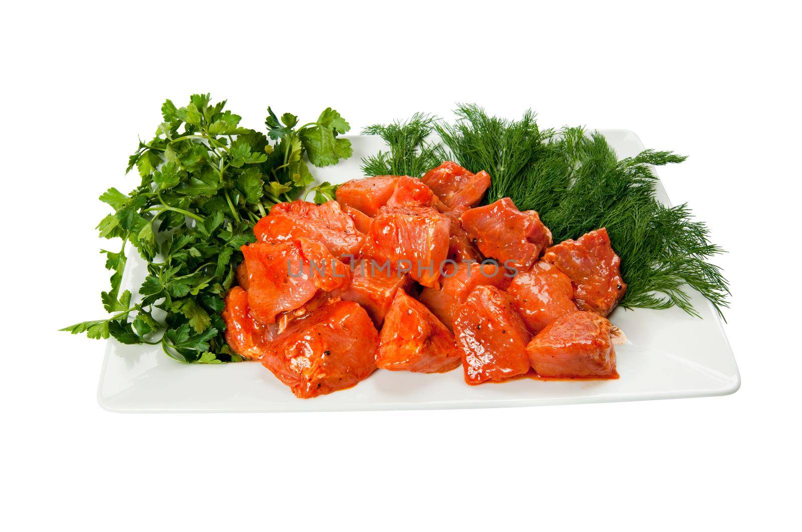 Shashlik or Shish Kebab on a plate with dill and parsley