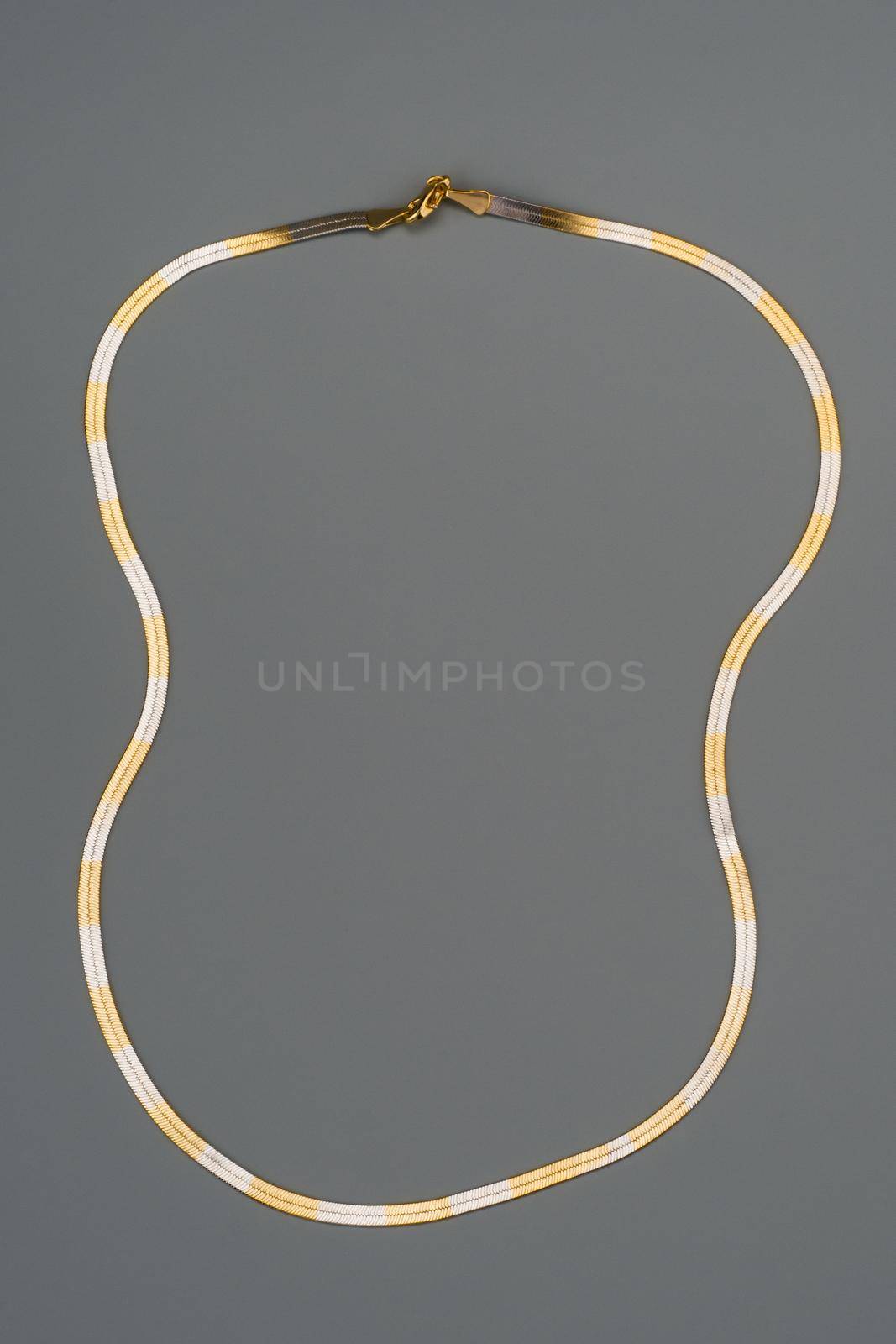 Luxury golden necklace on gray background