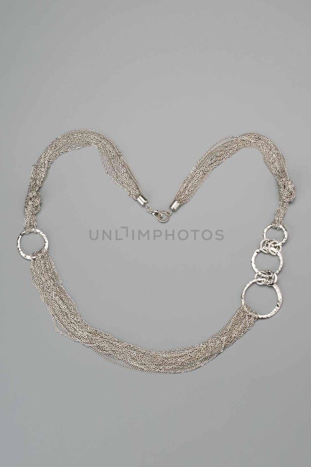 Luxury silver necklace on gray background