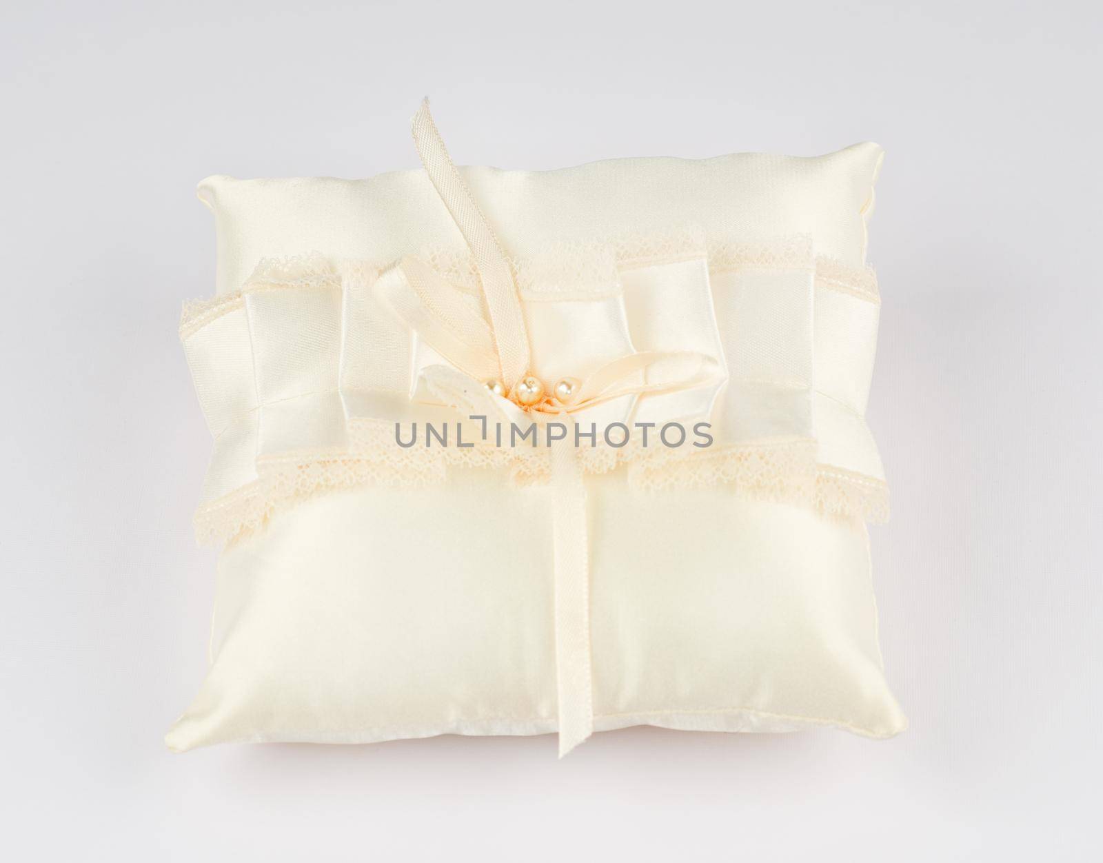 Exquisite pillow for wedding rings on gray background