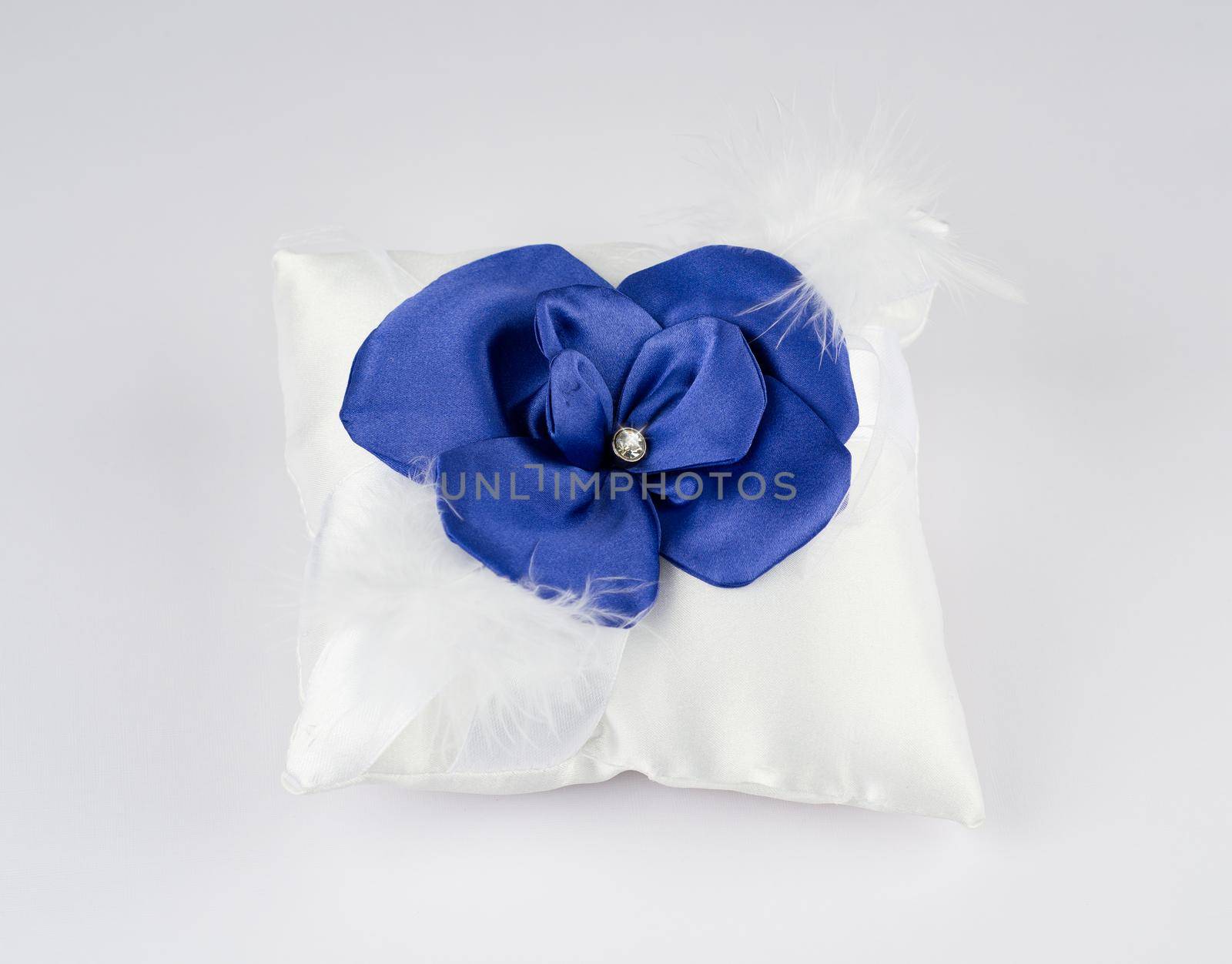 Exquisite pillow for wedding rings on gray background