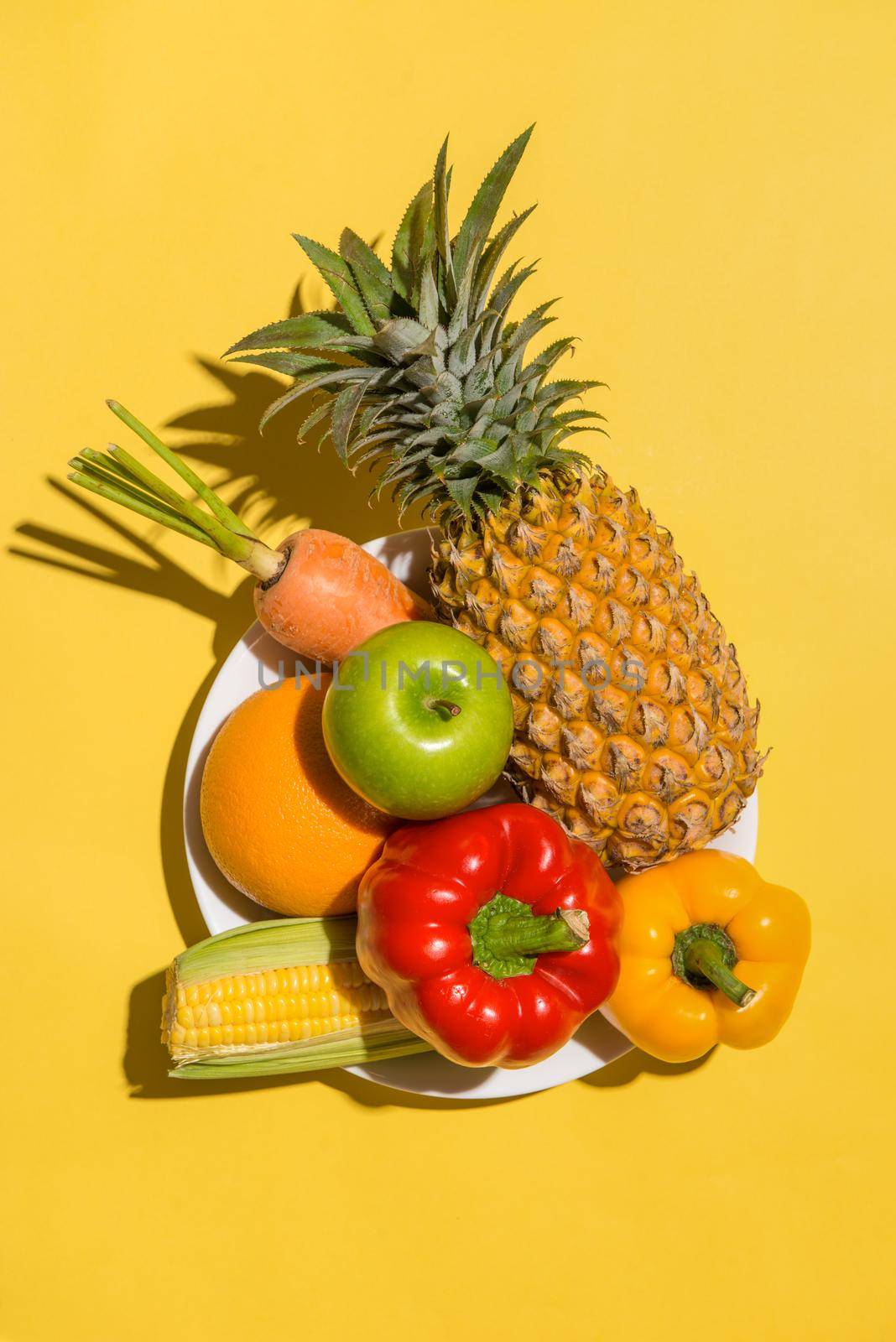 Fresh fruits on yellow background
