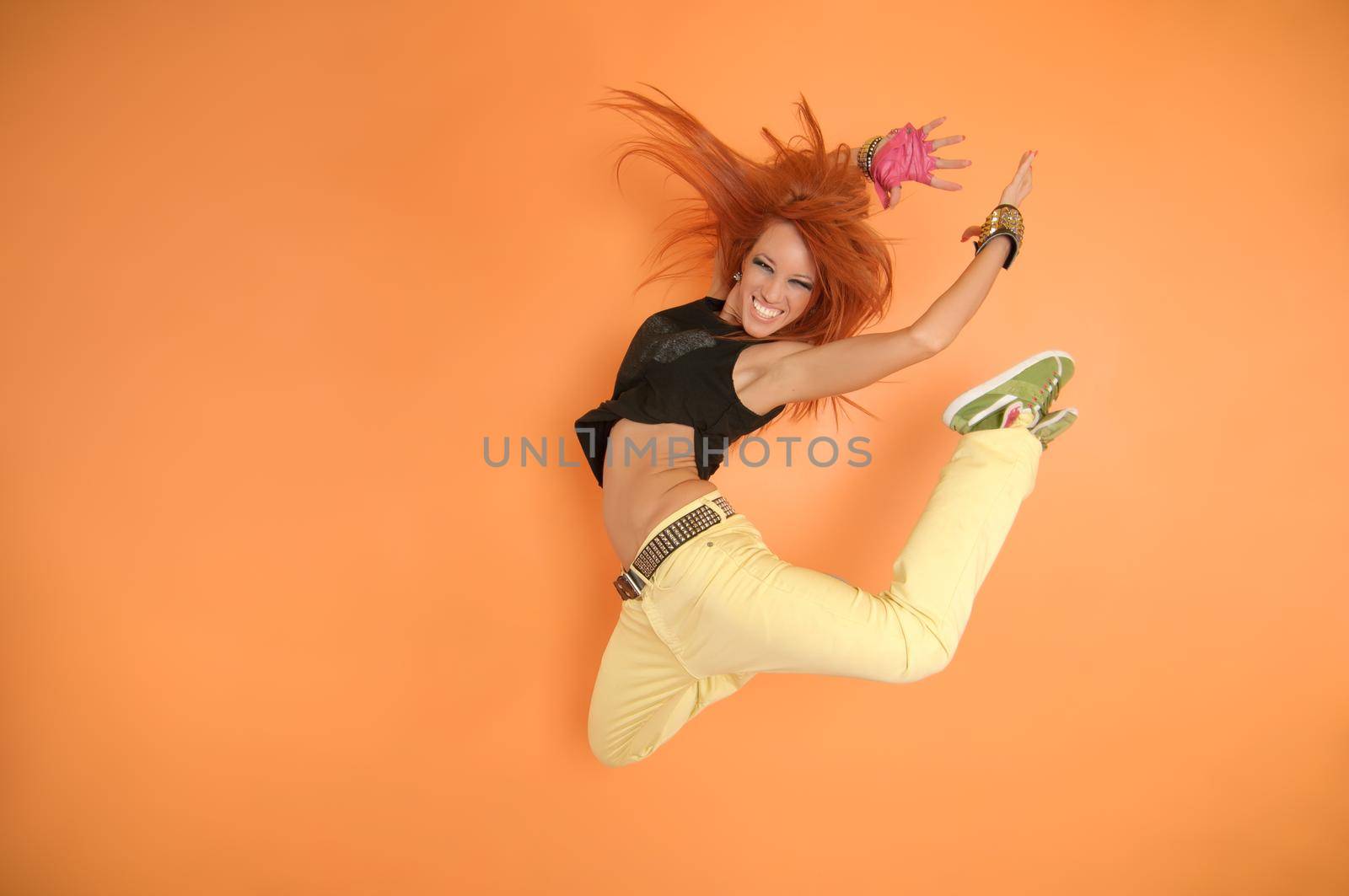 Modern dancer poses in front of the vivid background