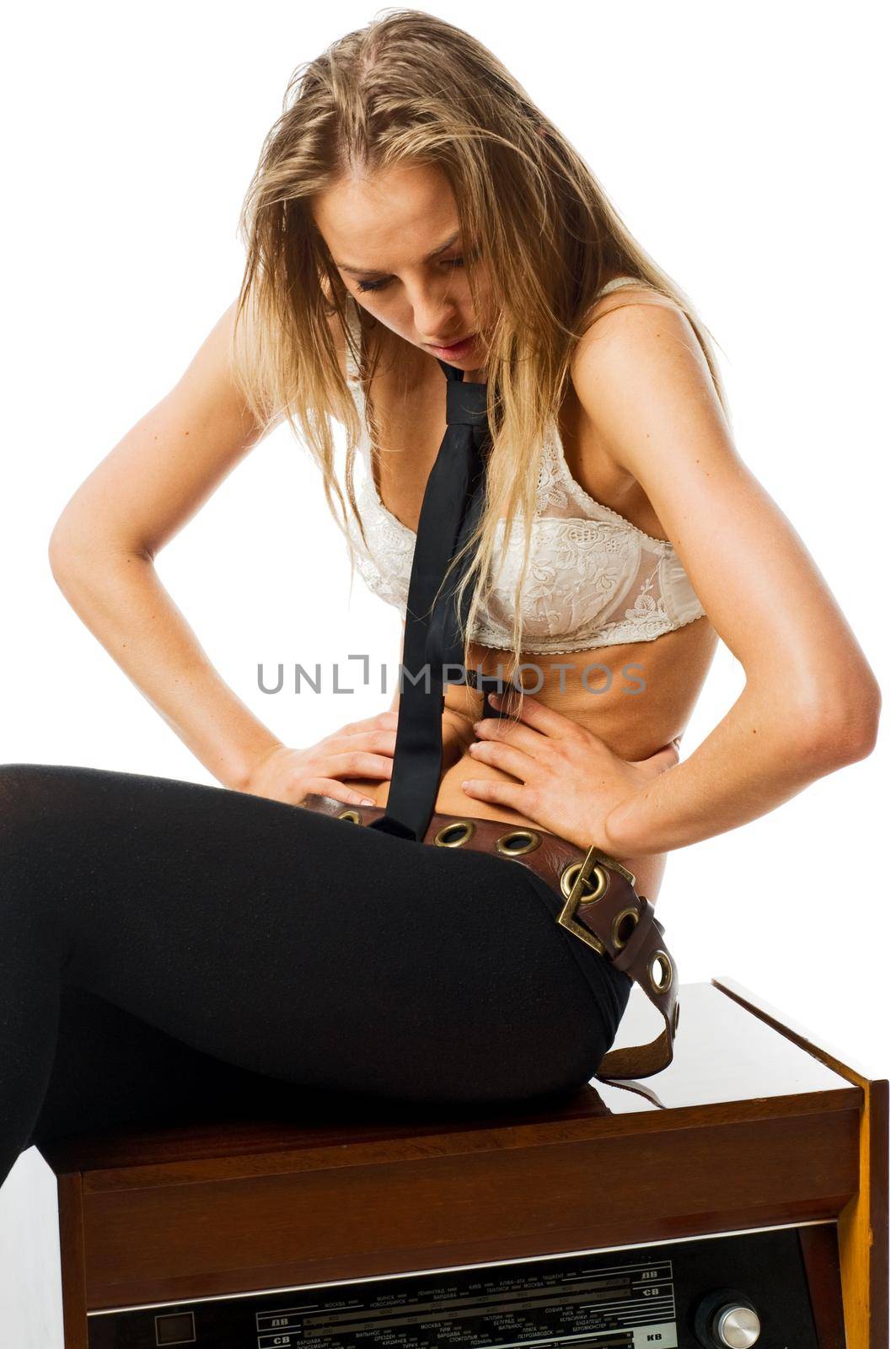 Young slim caucasian woman with old radio isolated on white background