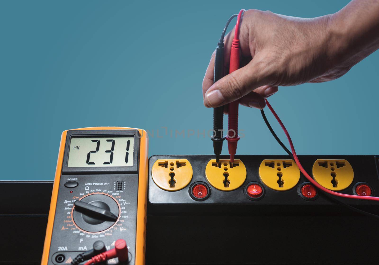 Measure the AC voltage of 230 Volts from the power outlet with a digital meter. by wattanaphob