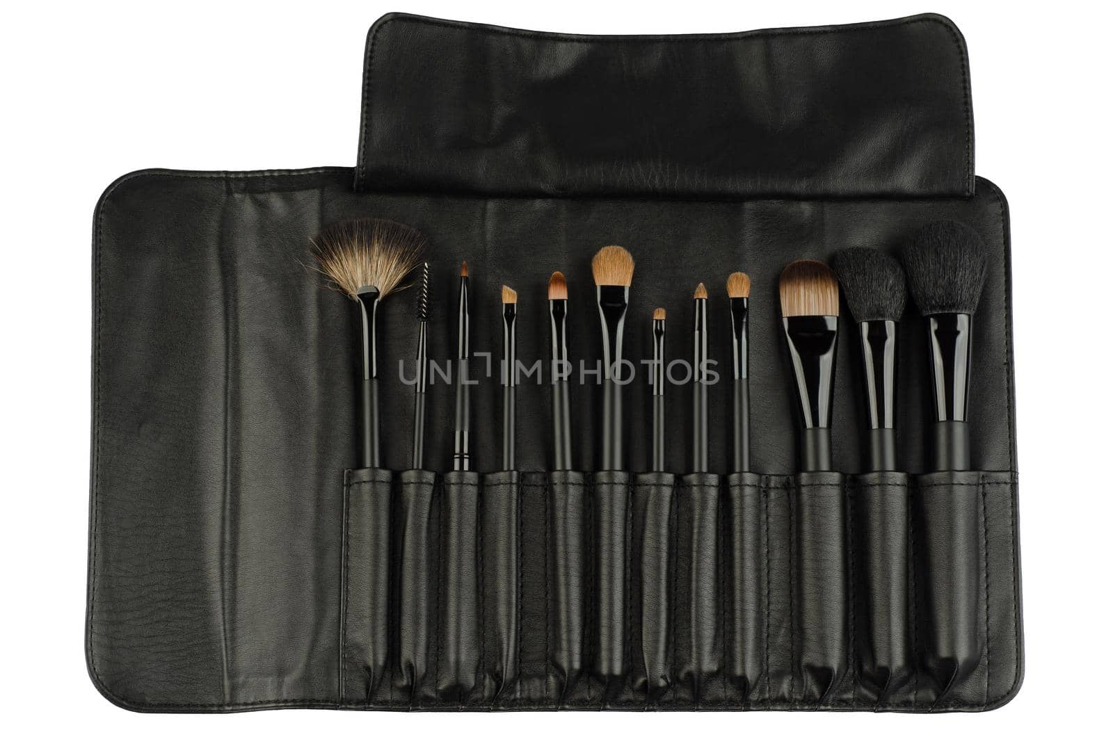 Set of black makeup brushes in leather case isolated