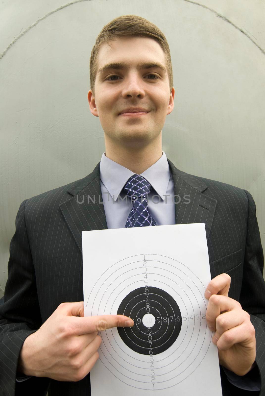 Young businessman points right at the bull's-eye