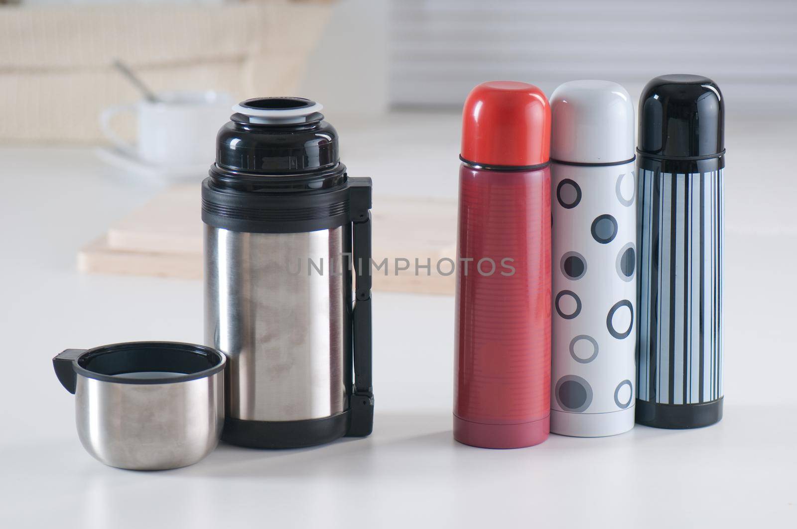 Set of vacuum flasks on a kitchen table