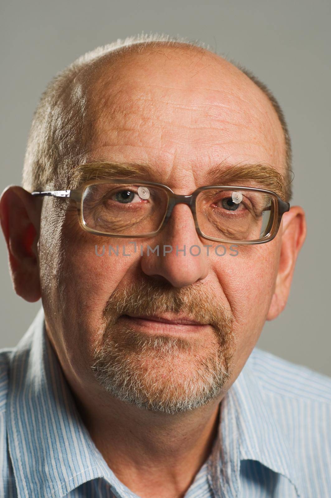 Handsome mature man posing on plain background