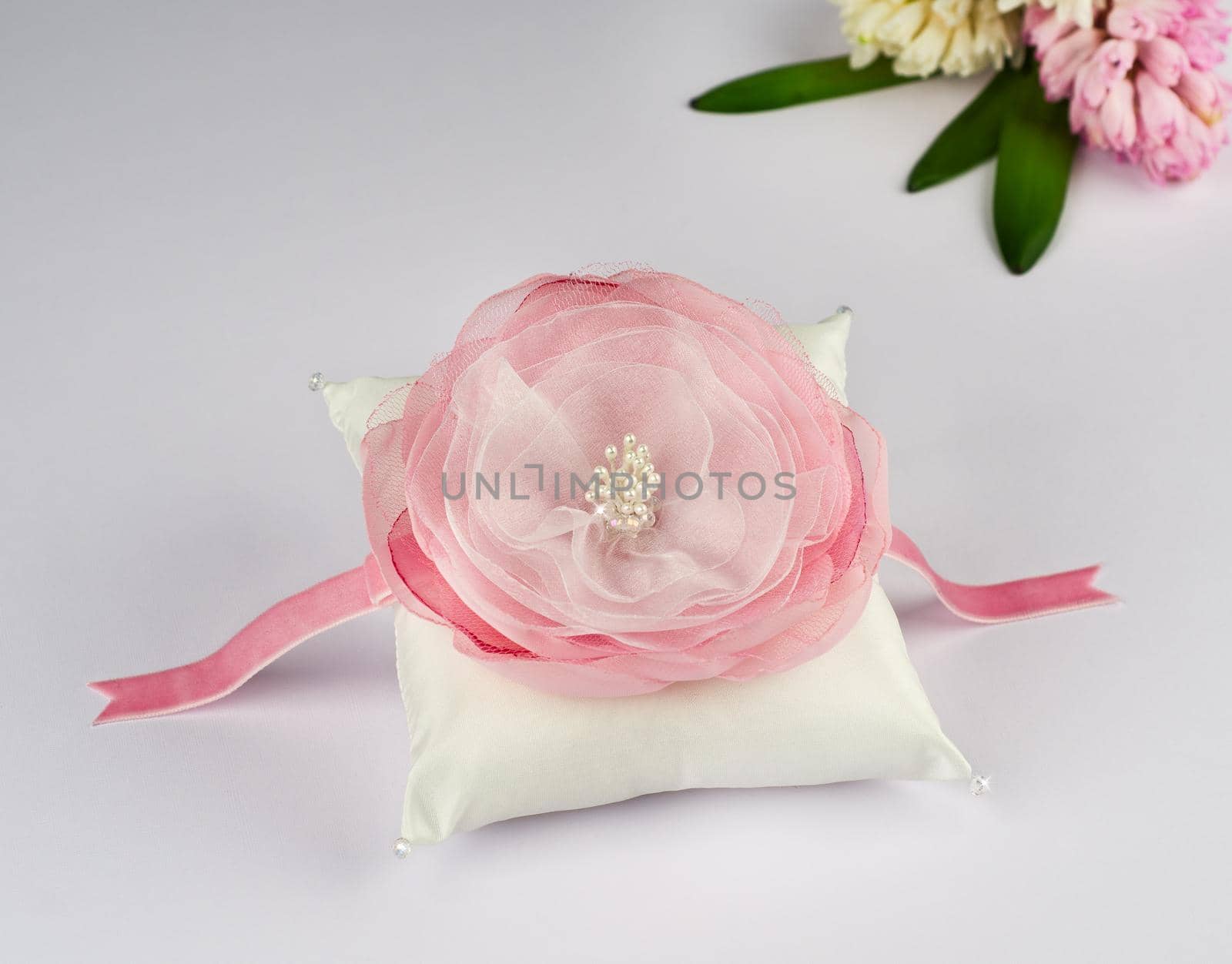 Exquisite pillow for wedding rings on gray background