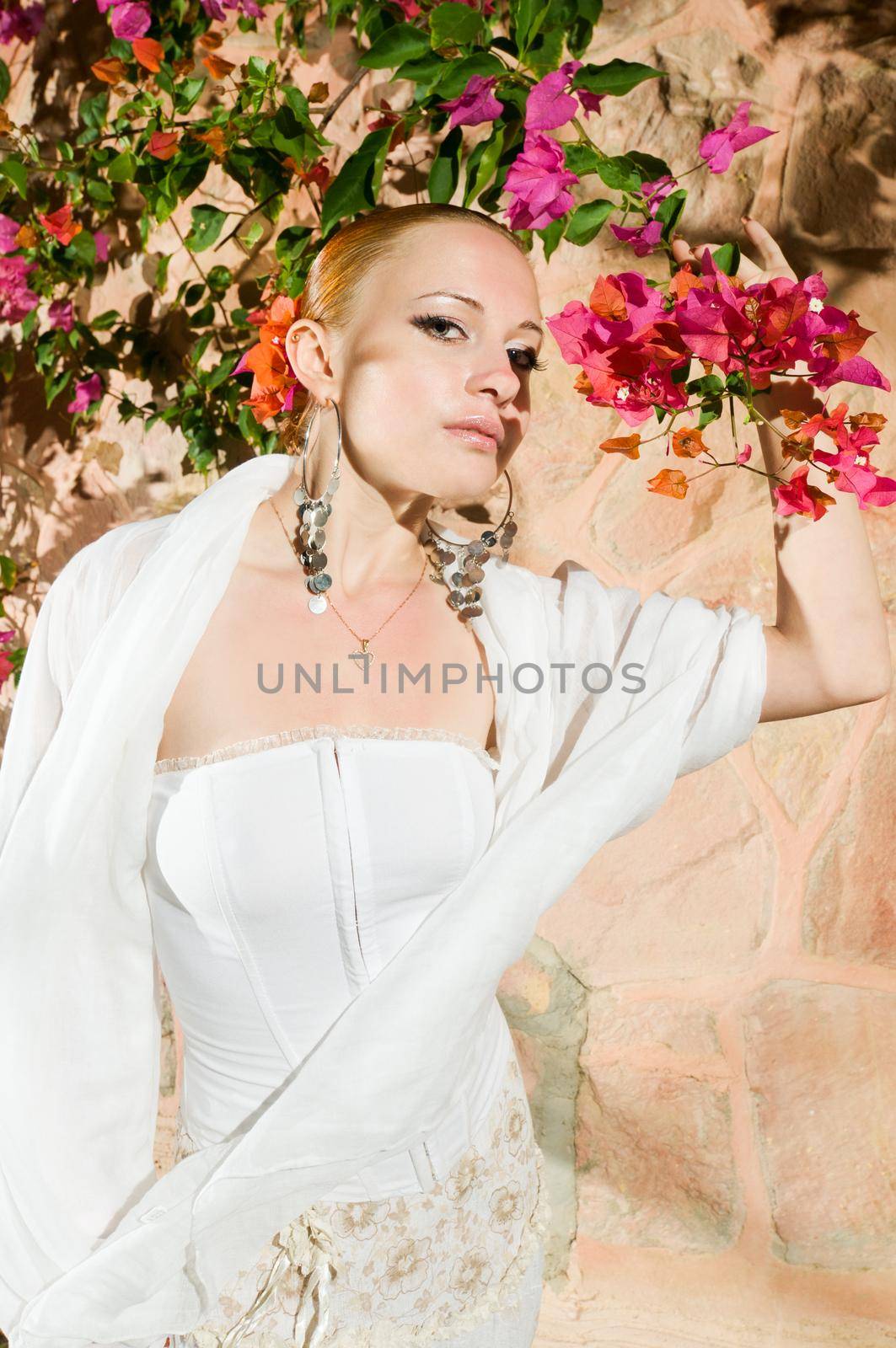 Beautiful red woman wearing traditional flamenco dress with flower in hair