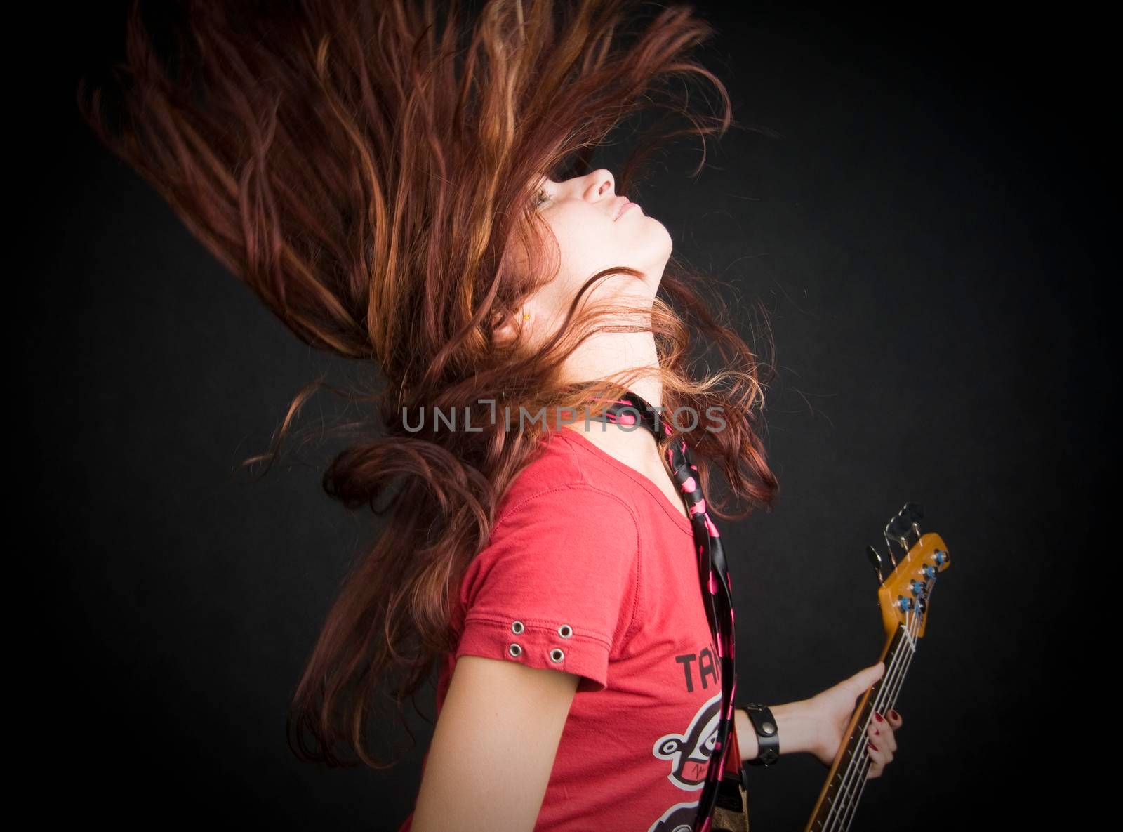 Portrait of a beautiful red haired girl on black background