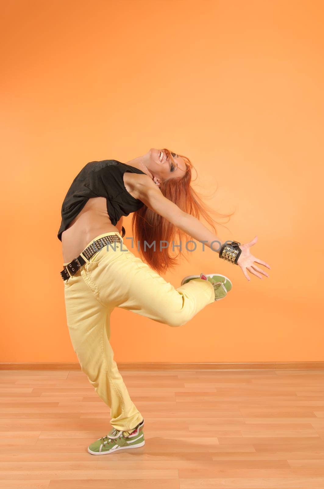 Modern dancer poses in front of the vivid background