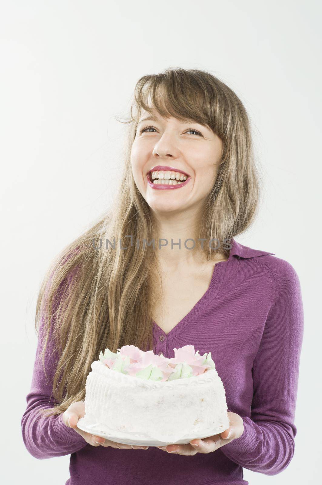Beautiful young woman with delicious candy over plain background