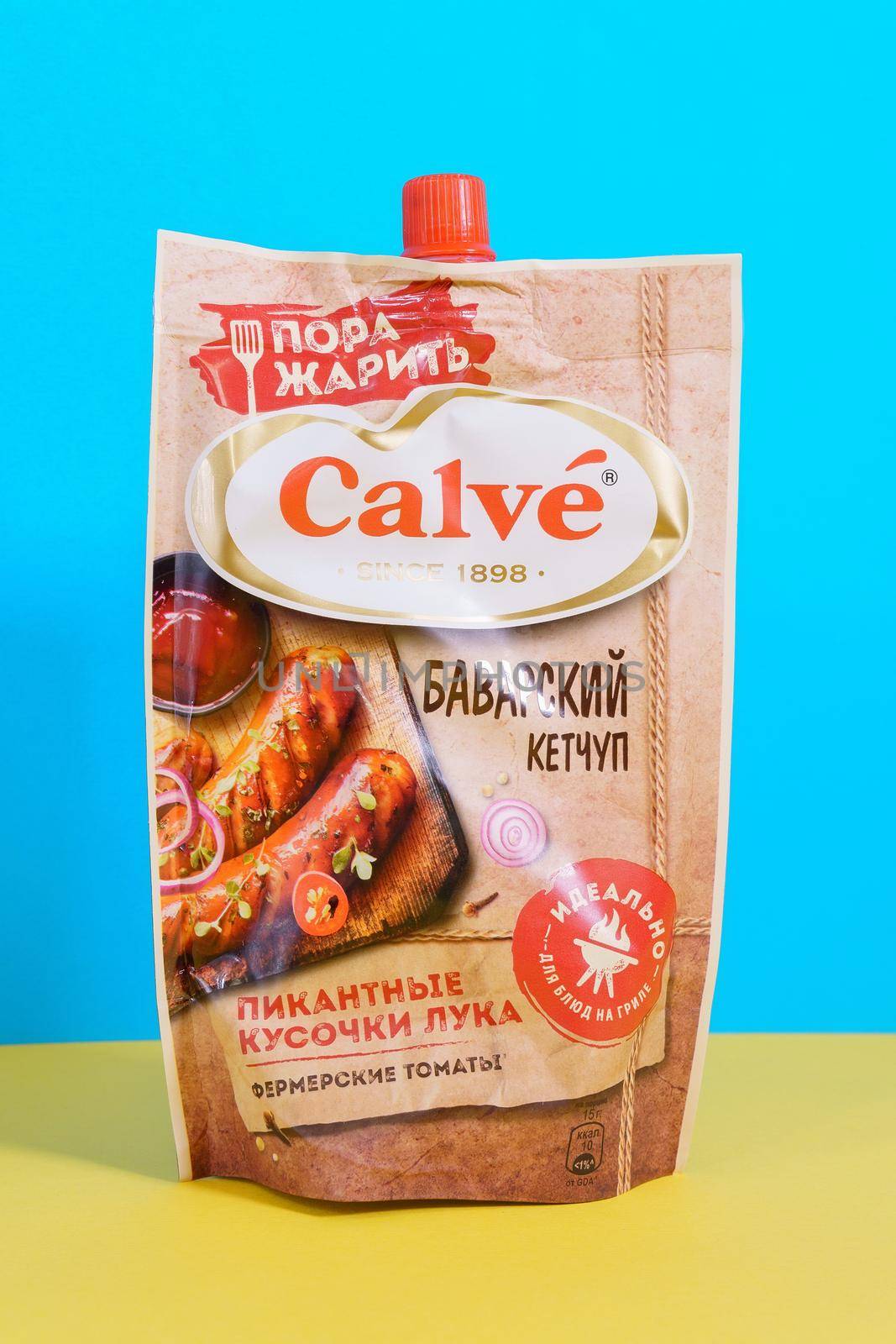 Tyumen, Russia-april 17, 2021: Calve Bavarian ketchup on a yellow blue background. russian packaging by darksoul72