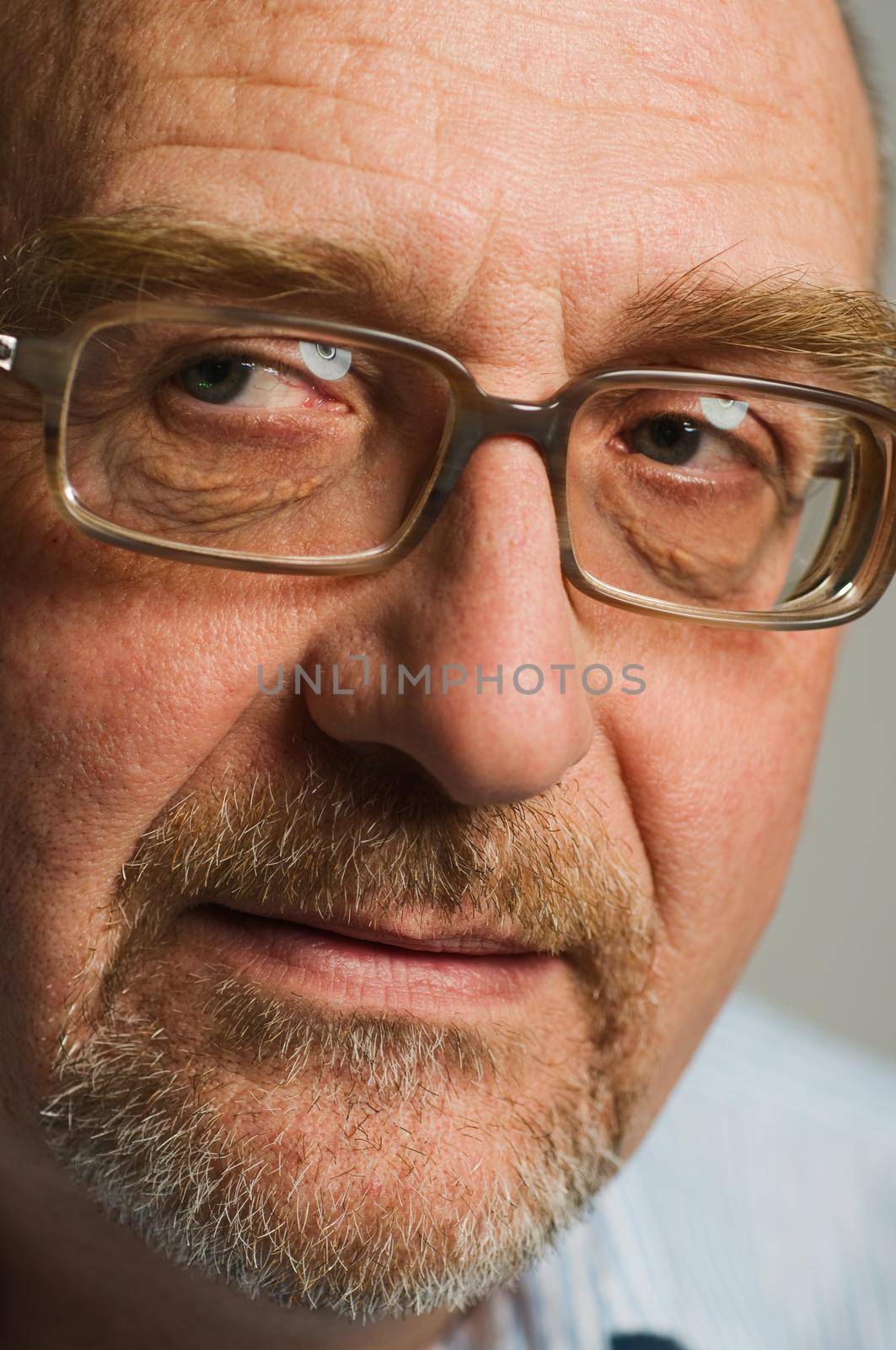 Handsome mature man posing on plain background