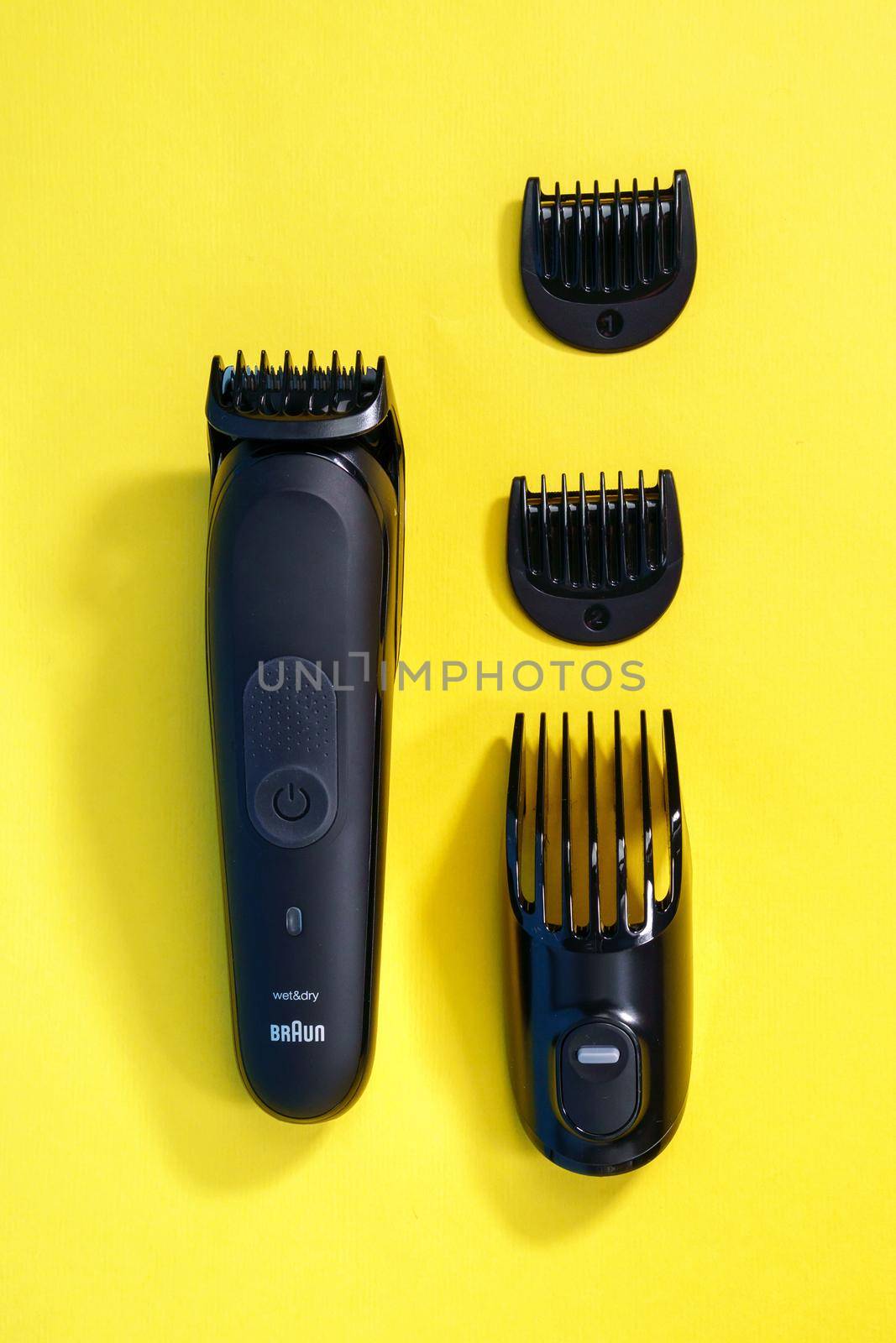 Tyumen, Russia - April 14, 2021: Braun Wet and Dry Electric Mens Shaver. On a yellow background