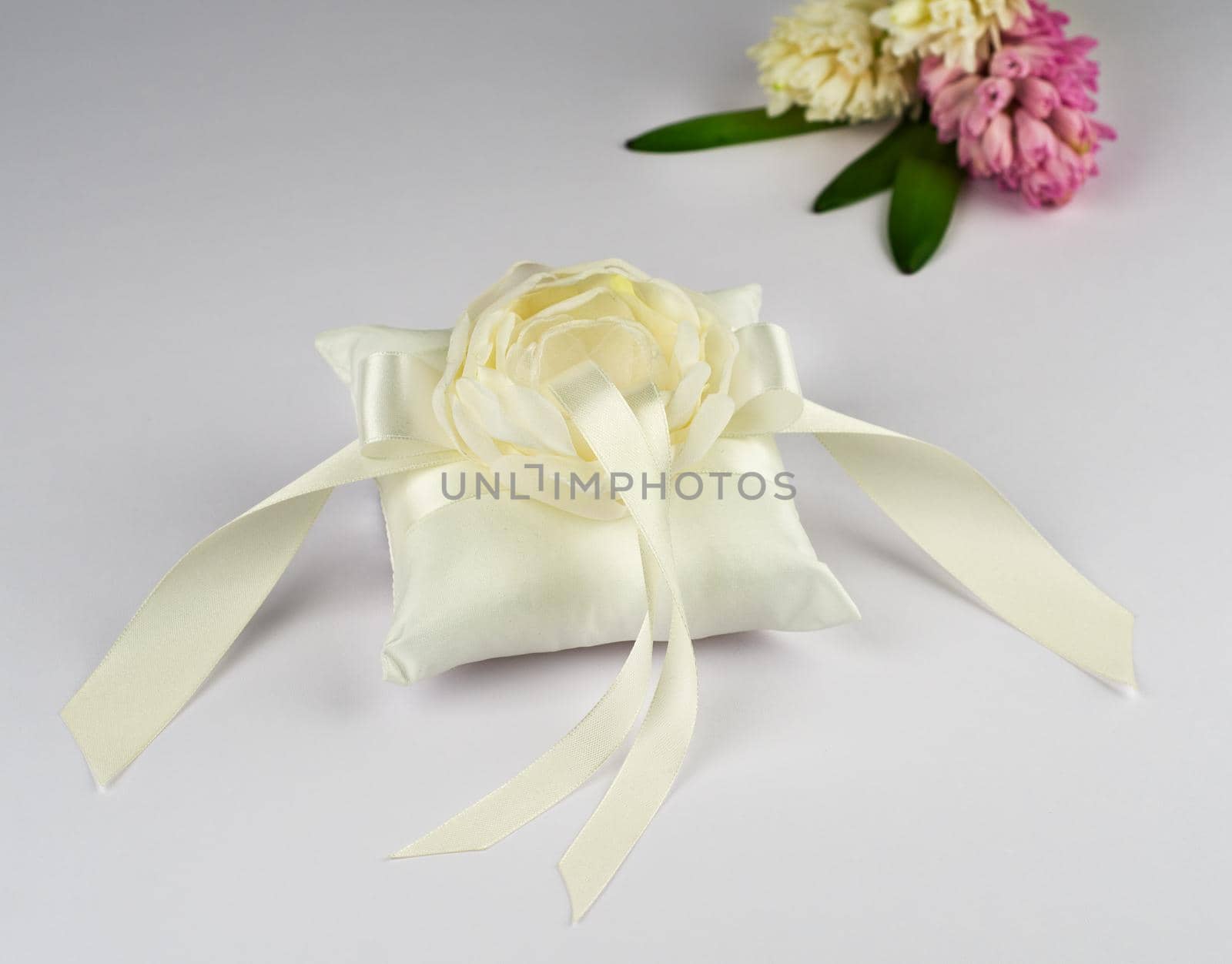 Exquisite pillow for wedding rings on gray background