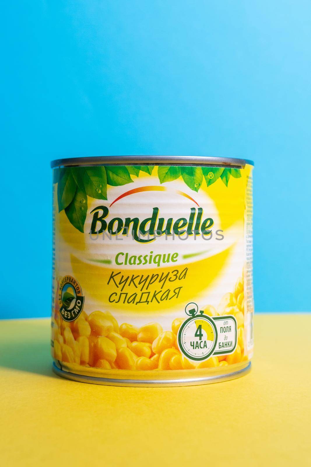 Tyumen, Russia-april 17, 2021: Bonduelle corn in tin cans on a yellow blue background. Vertical photo by darksoul72