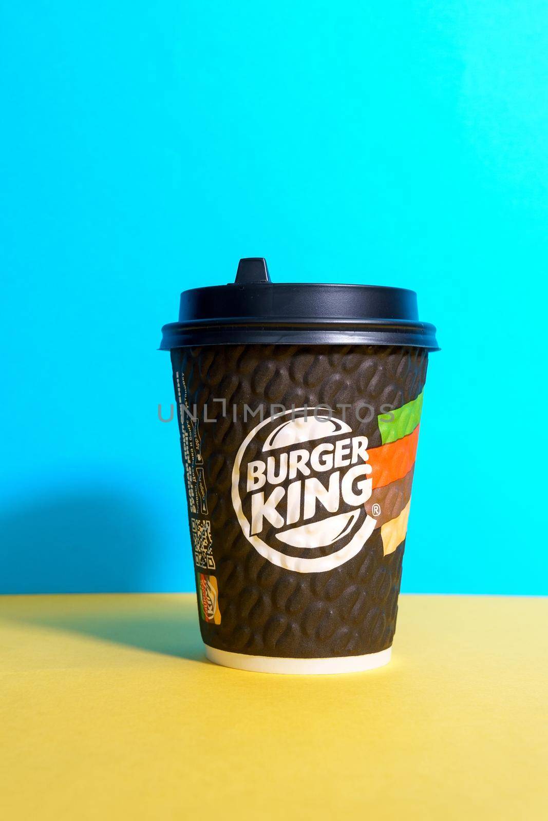 Tyumen, Russia - April 14, 2021: Coffee from a fast food restaurant Burger King logo. Vertical photo