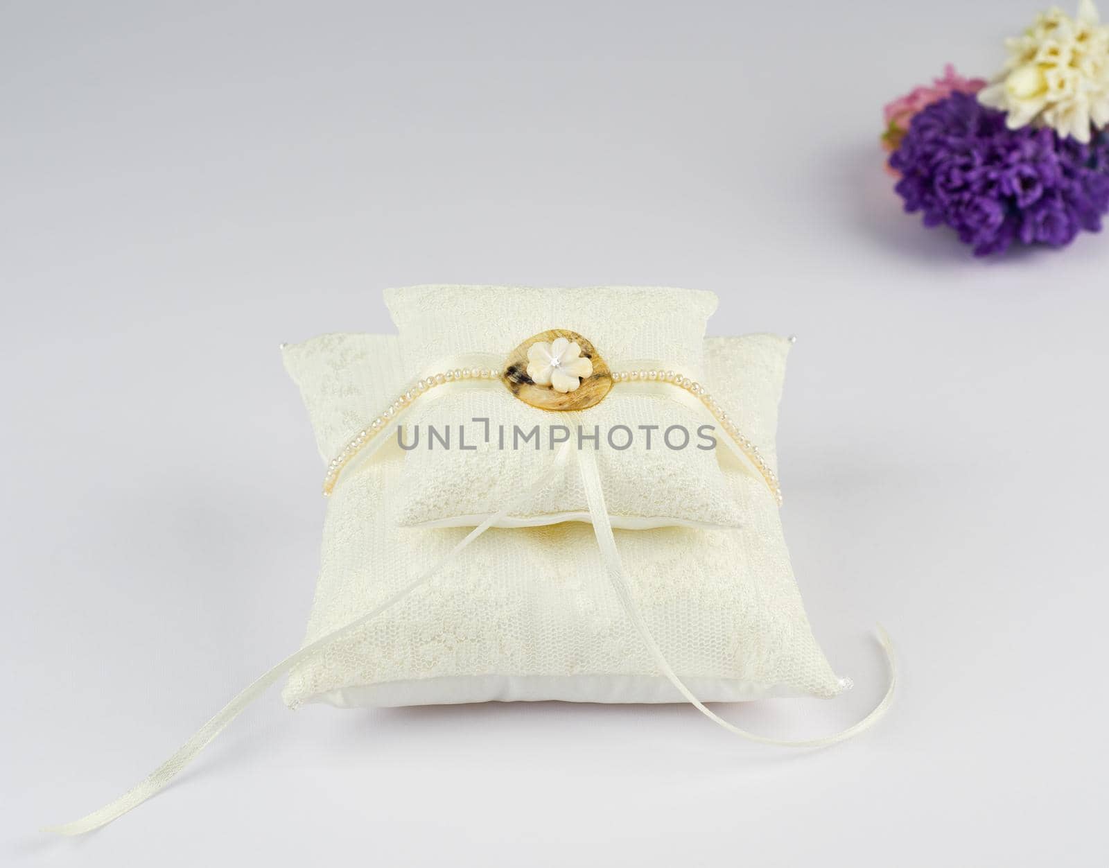 Exquisite pillow for wedding rings on gray background