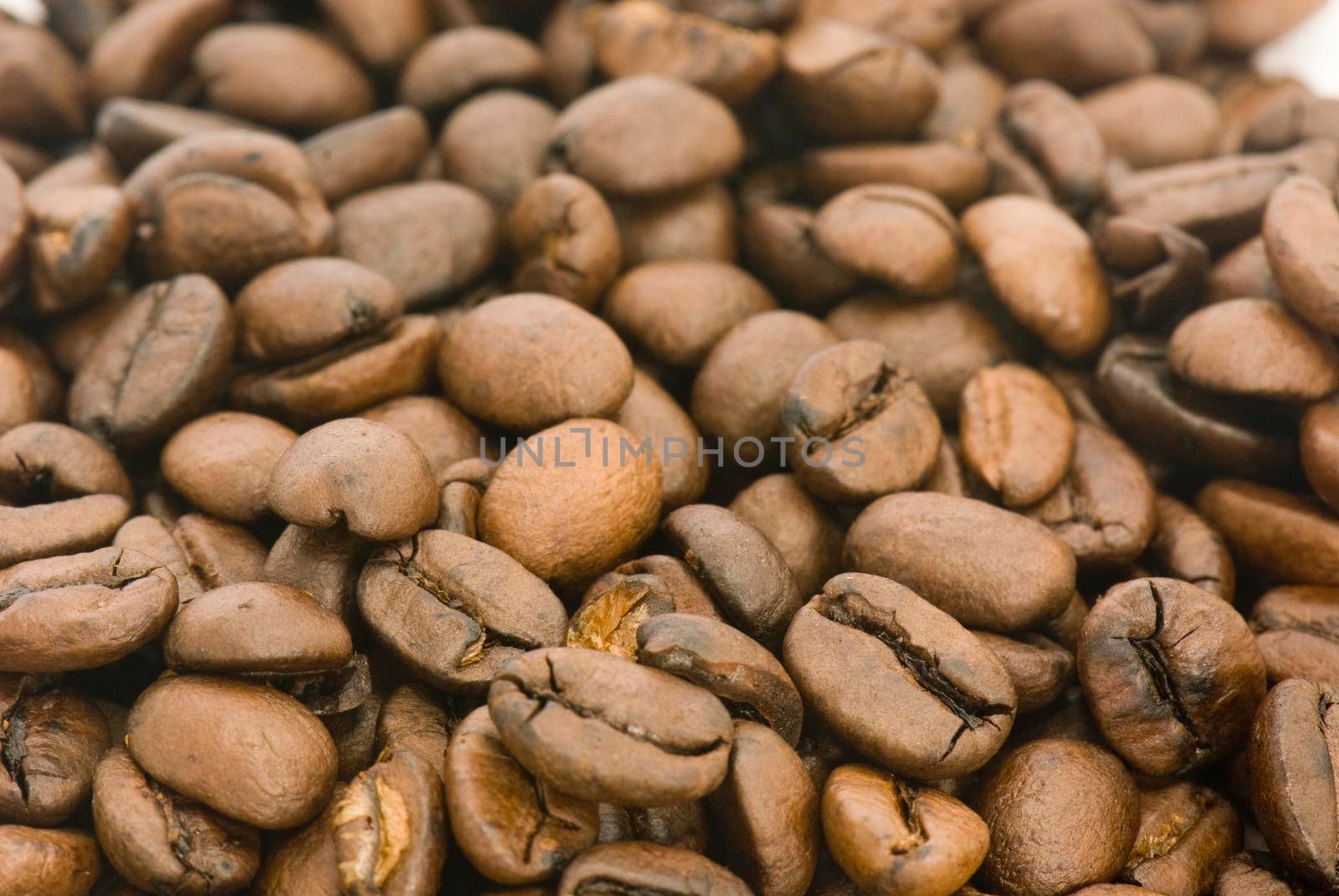 Pile of roasted coffee beans with white background