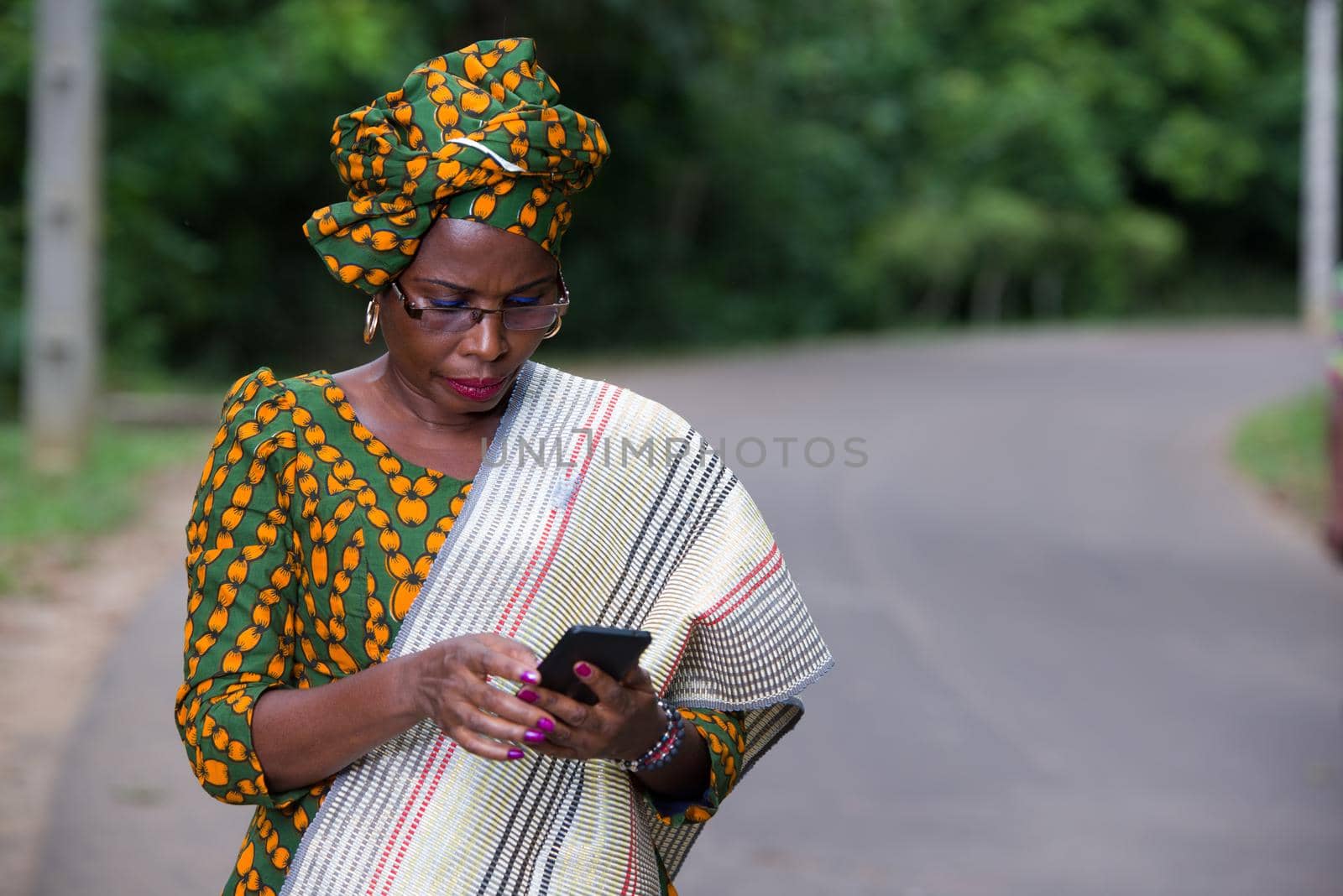 portrait of young african woman with mobile phone. by vystek