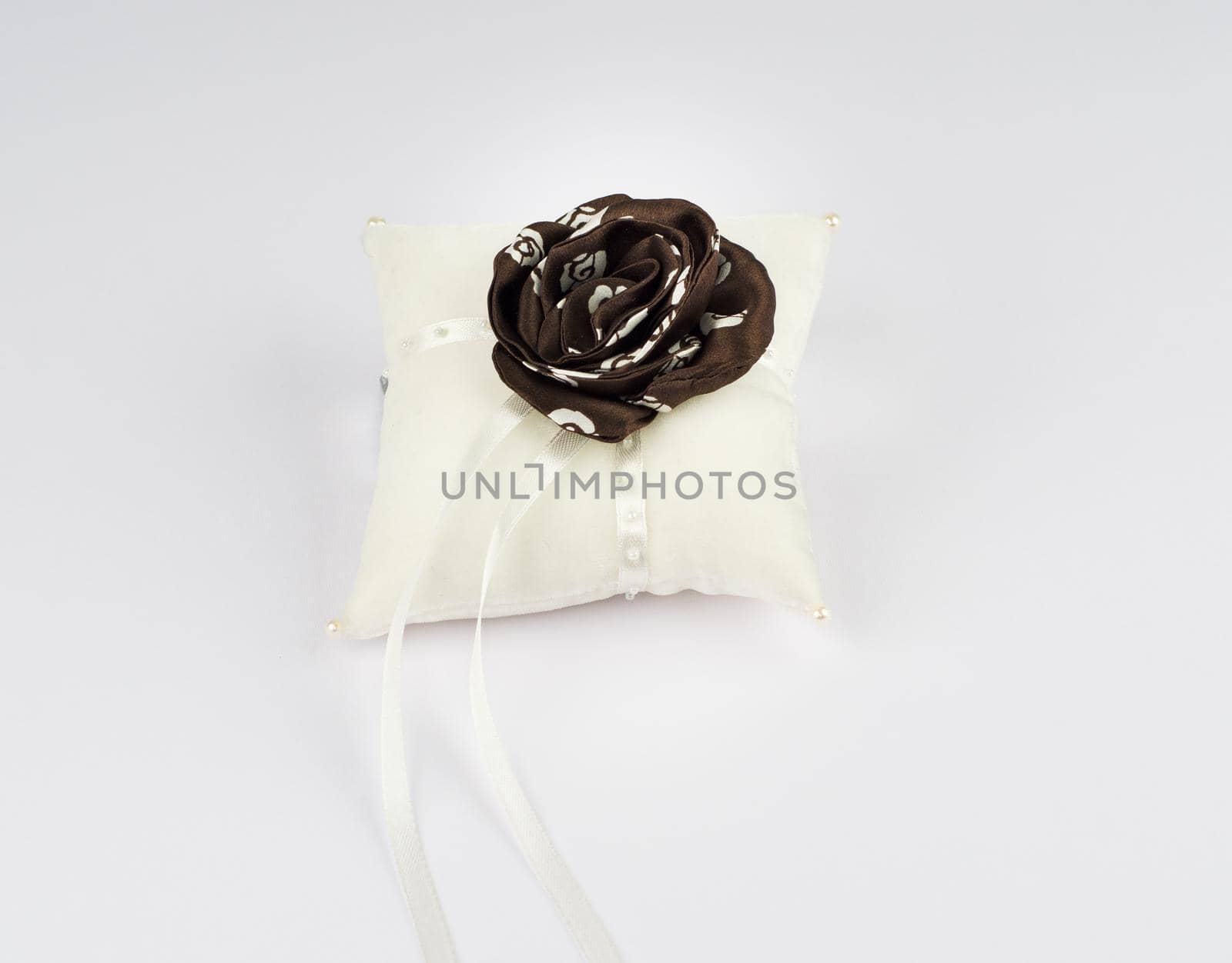 Exquisite pillow for wedding rings on gray background