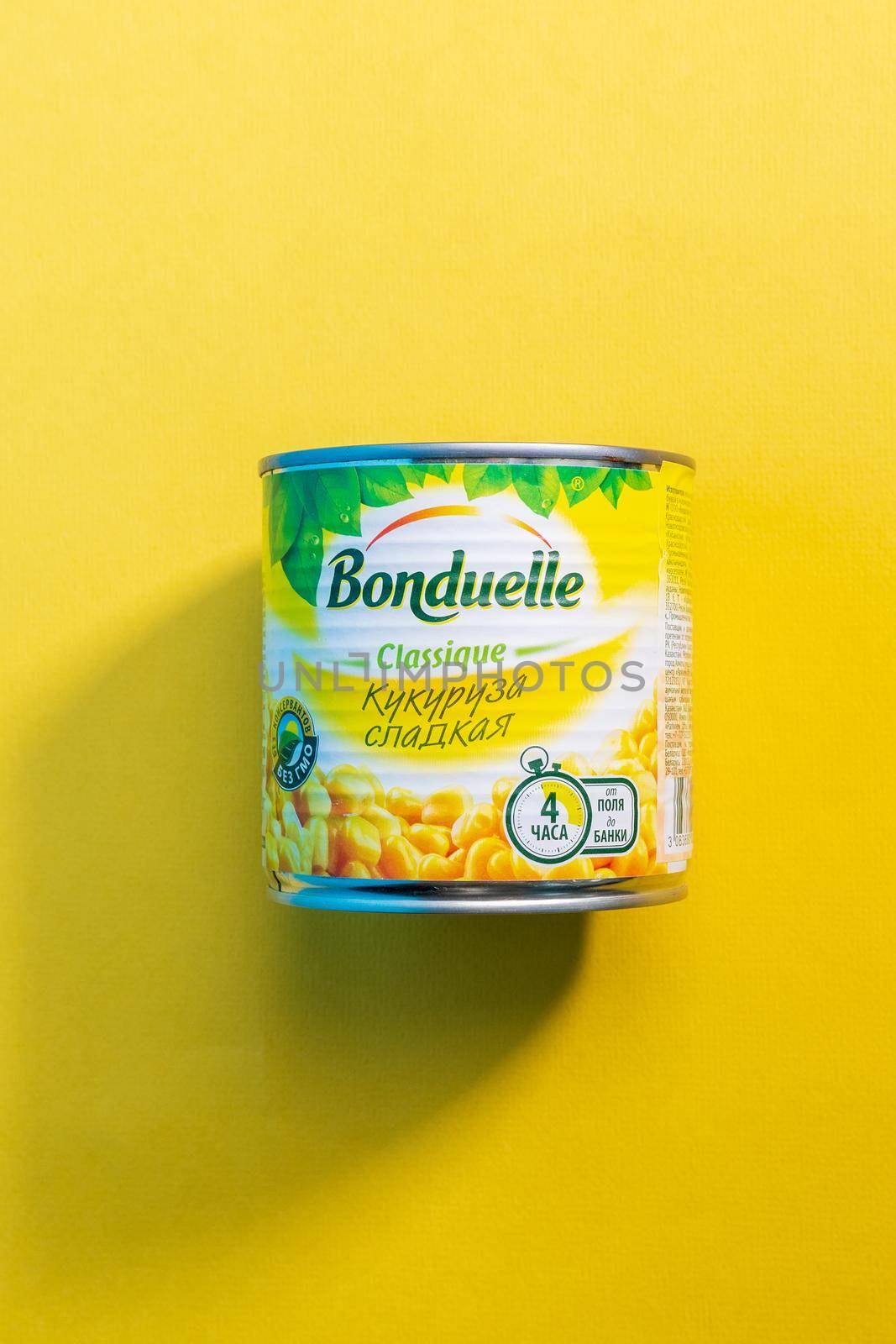 Tyumen, Russia-april 17, 2021: Bonduelle corn in tin cans on a yellow background. Vertical photo by darksoul72