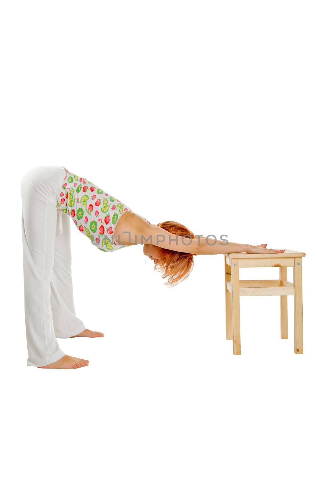 Red haired girl performing fitness exercises on white background
