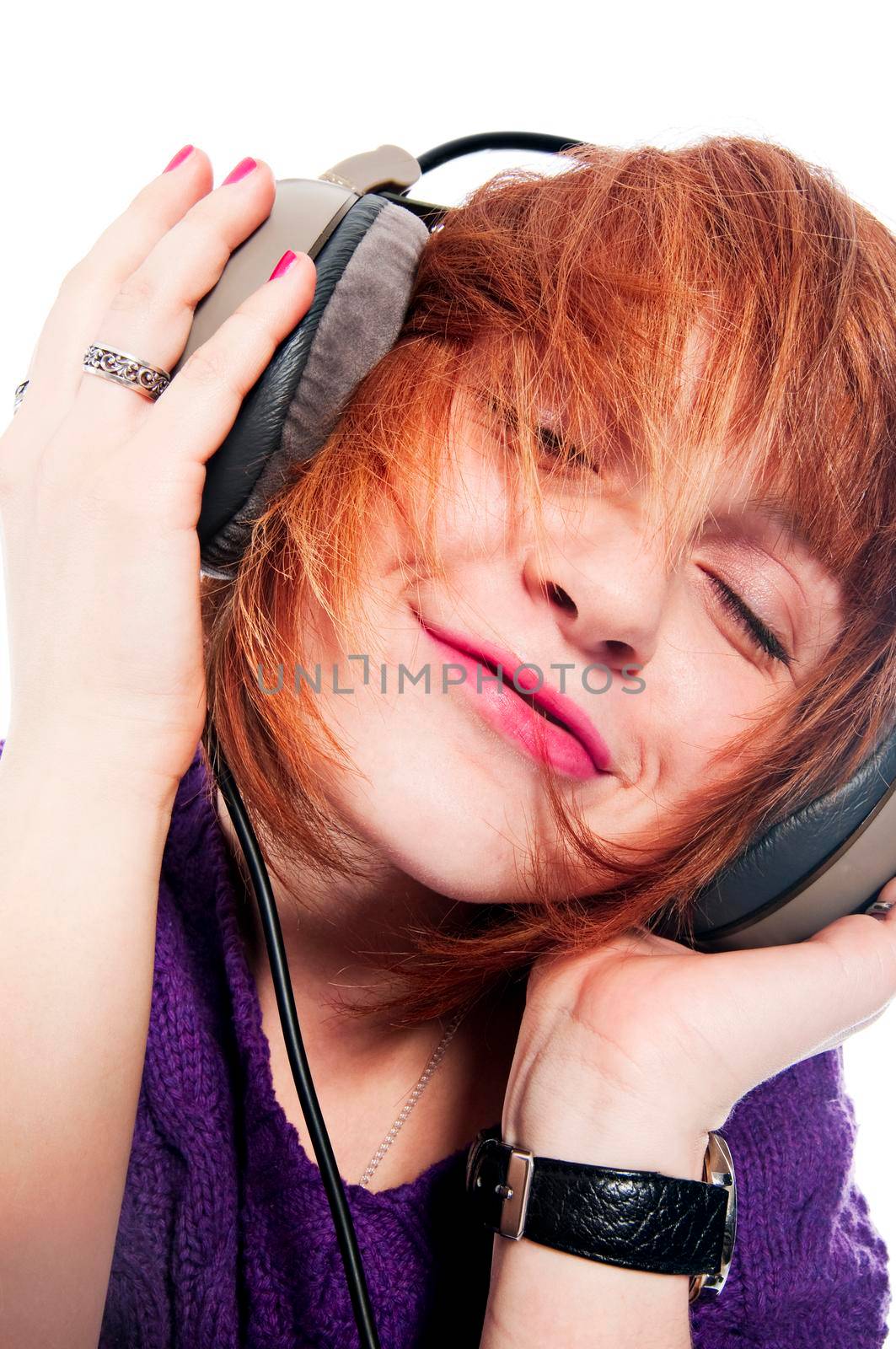 Beautiful girl listening to the music isolated on white