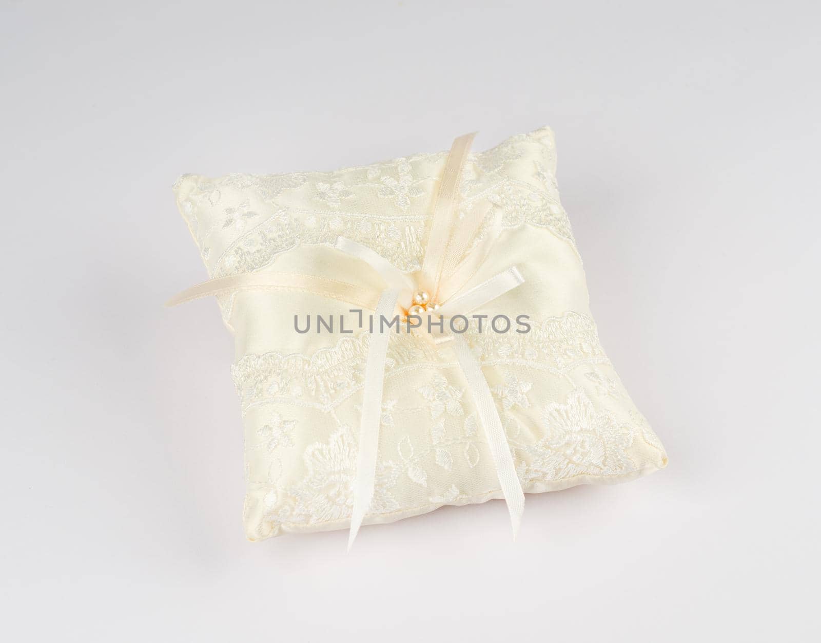 Exquisite pillow for wedding rings on gray background