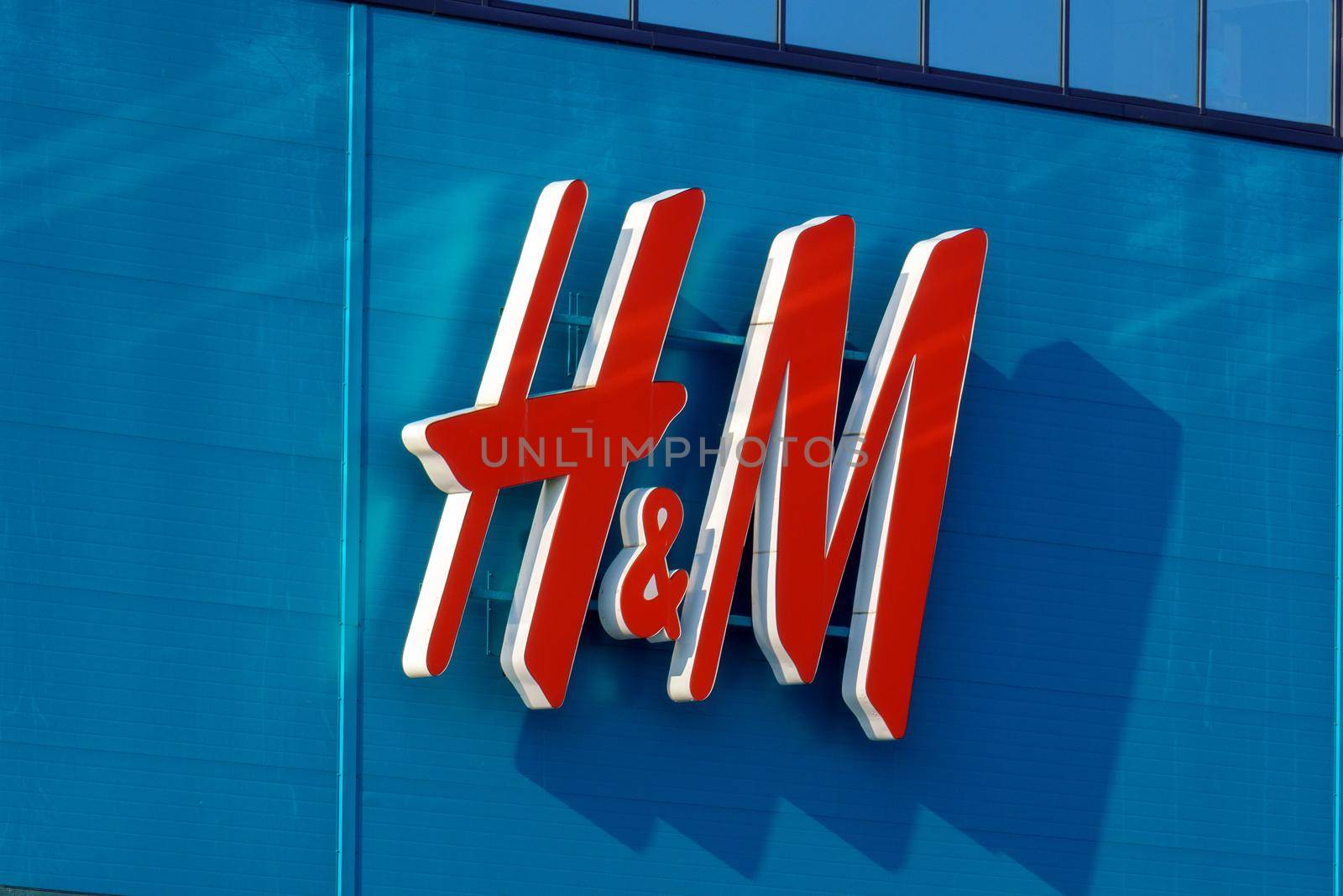 Tyumen, Russia-August 01, 2021: Close up shot of H and M storefront. Fast fashion clothing