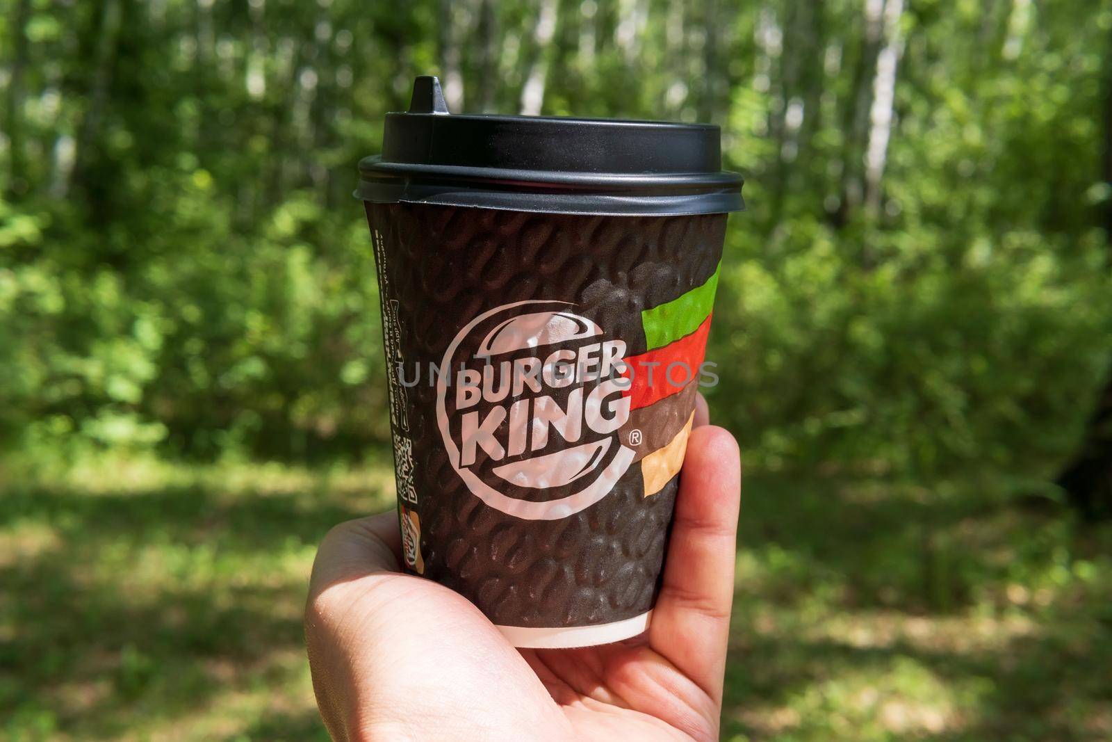 Tyumen, Russia-May 25, 2021: Coffee from a fast food restaurant Burger King logo in hand by darksoul72