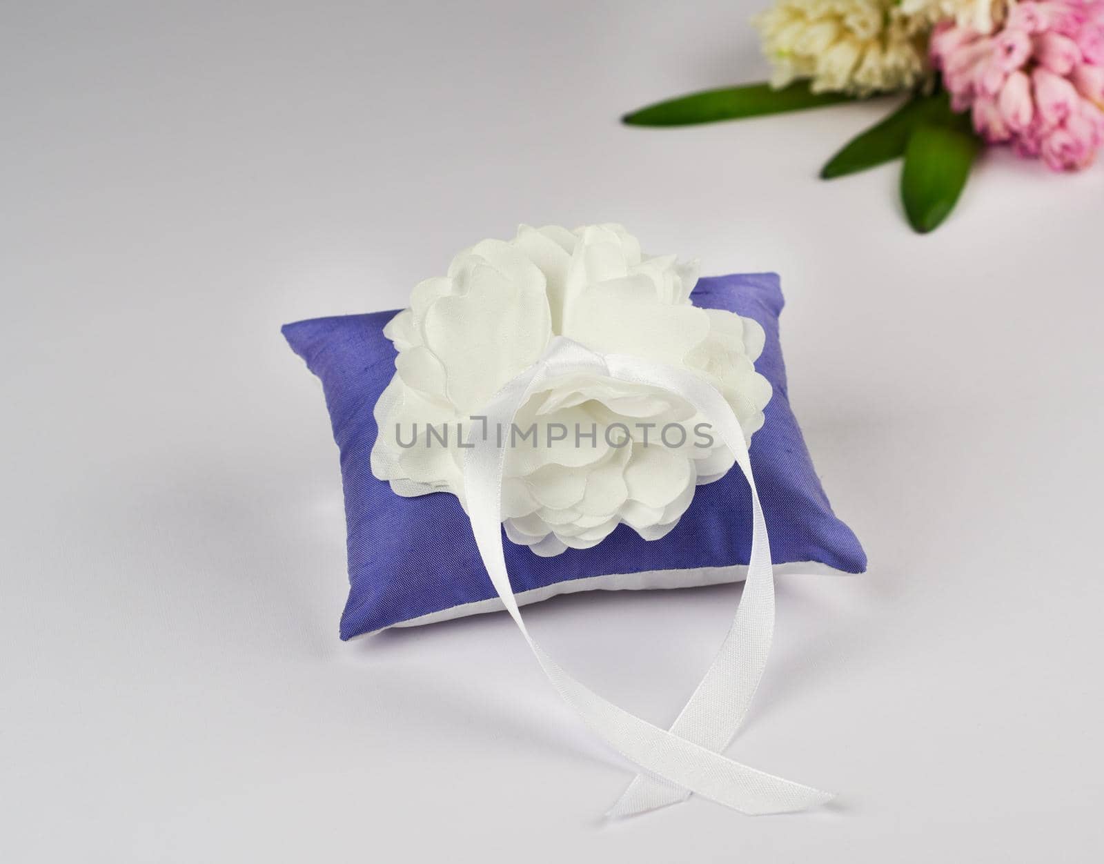 Exquisite pillow for wedding rings on gray background