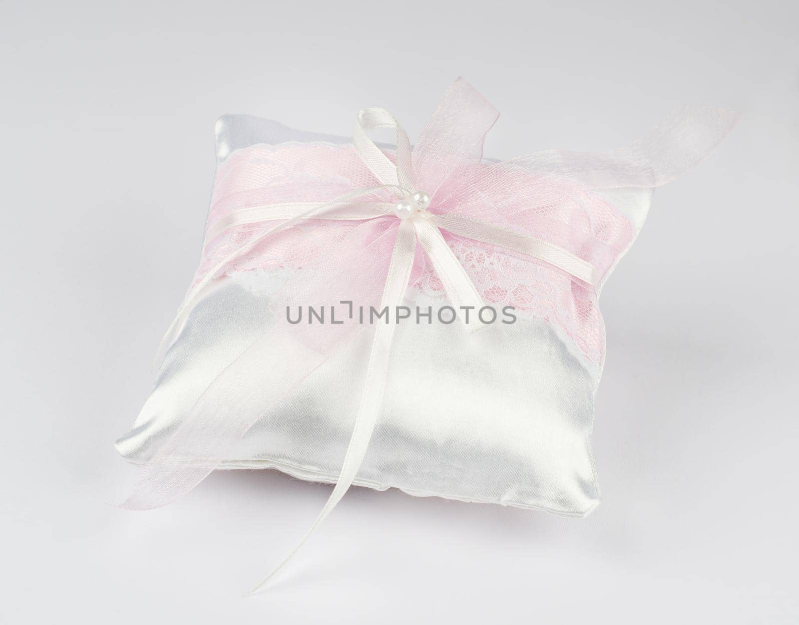 Exquisite pillow for wedding rings on gray background