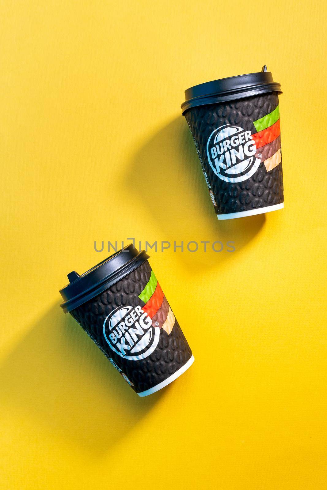 Tyumen, Russia - April 14, 2021: Coffee from a fast food restaurant Burger King. Yellow background by darksoul72