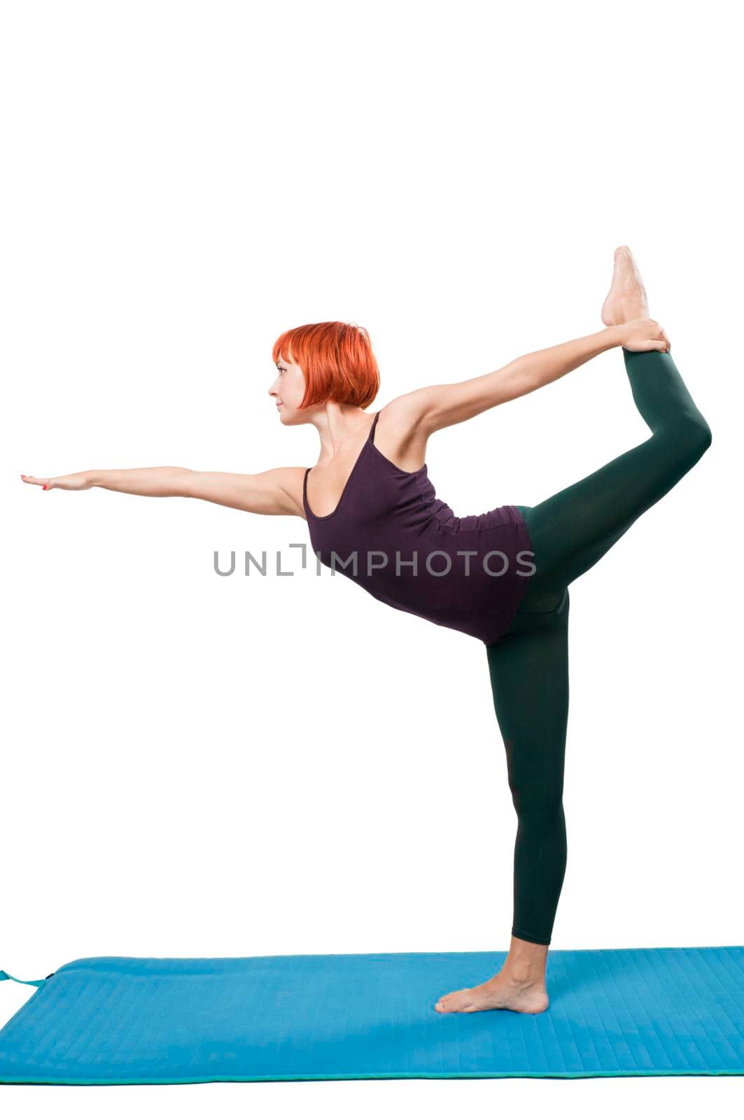 Red girl standing in yogatic asana on one leg