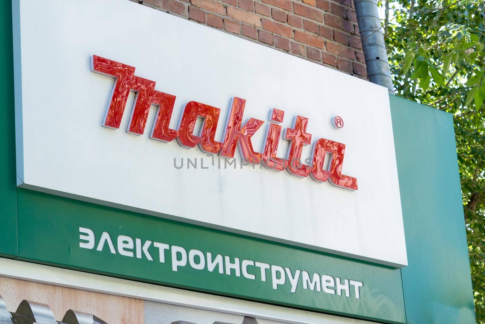 Tyumen, Russia-June 4, 2021: Makita logo in street, Japanese manufacturer of power tools. by darksoul72