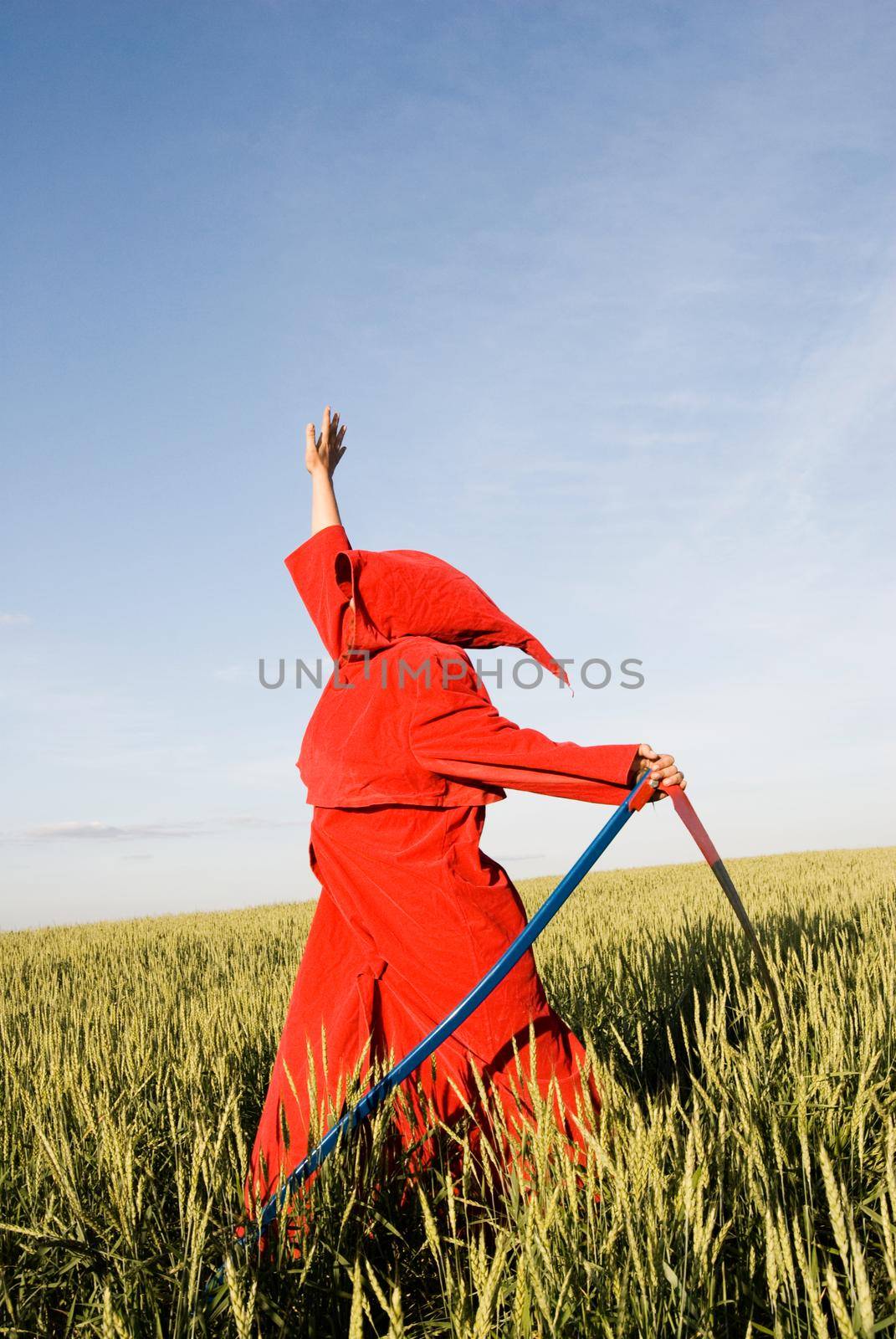 Spooky figure in red hood with a scythe