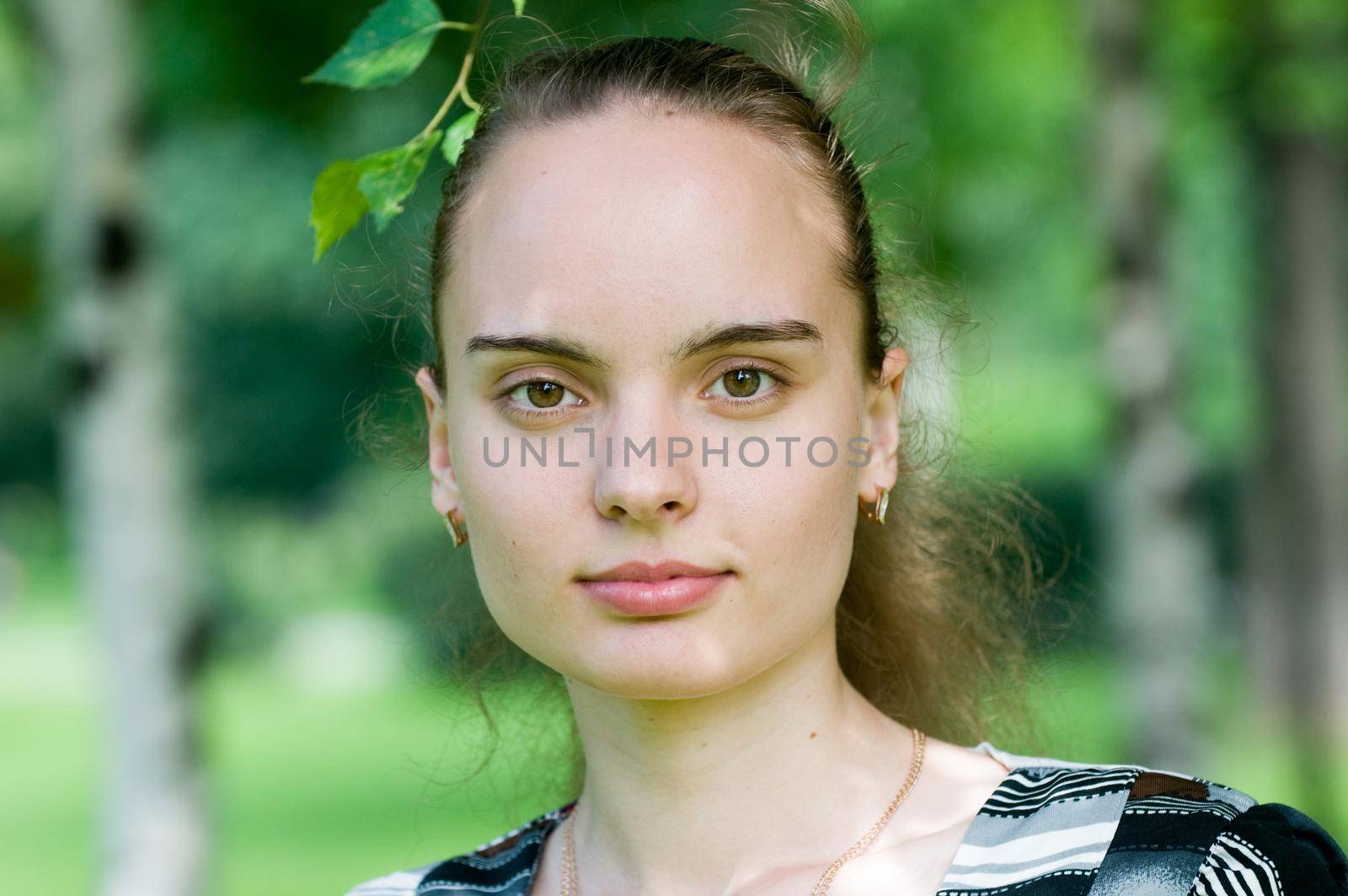 Portrait of a girl in a green park