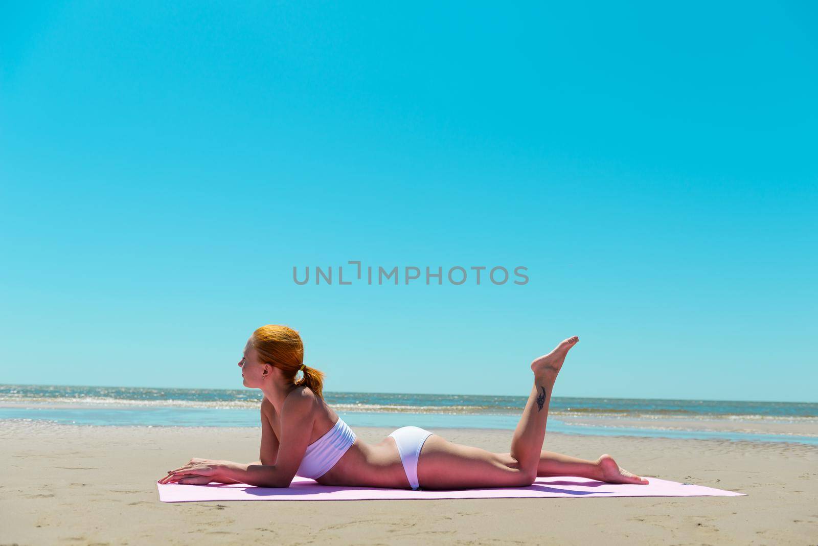 Sexy red woman wearing bikini on a beach