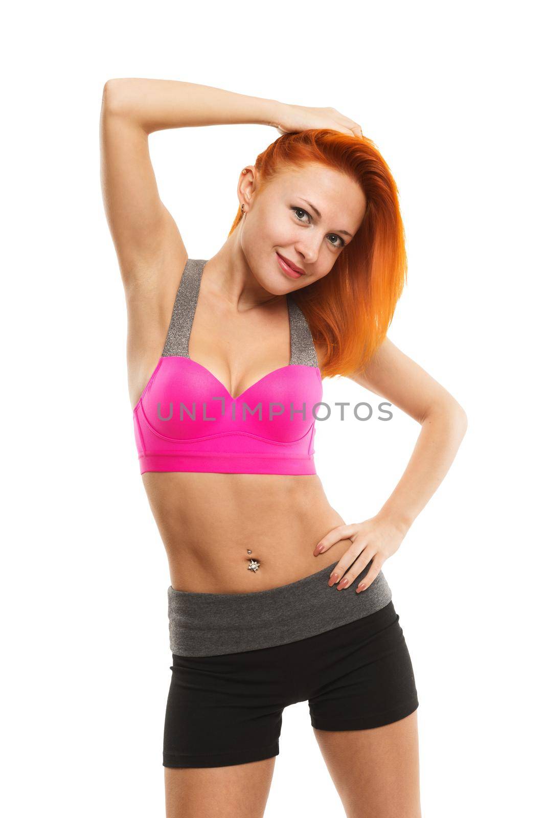 Young slim sensual red woman wearing sports bra practicing fitness