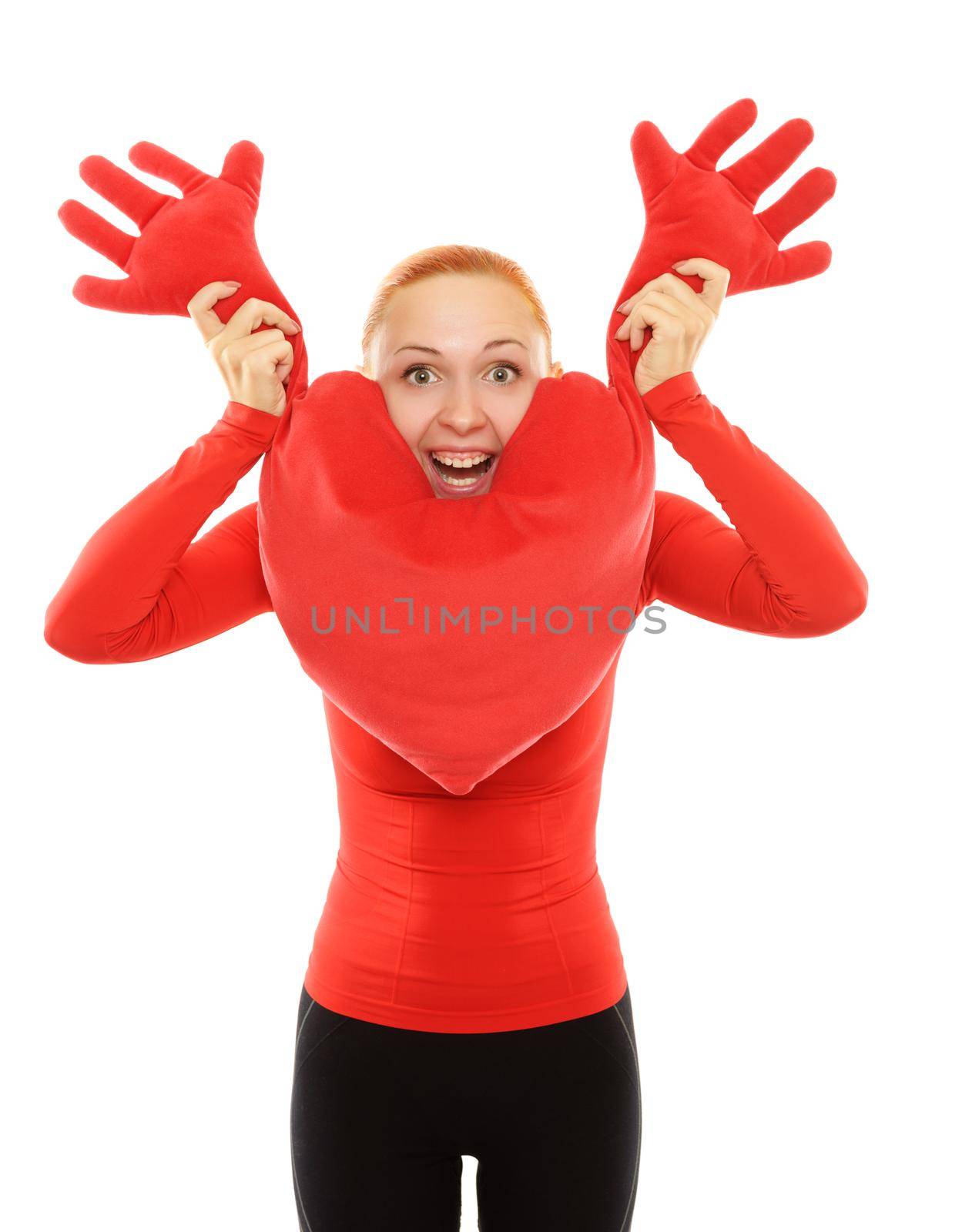 Cheerful young woman with big toy heart pillow