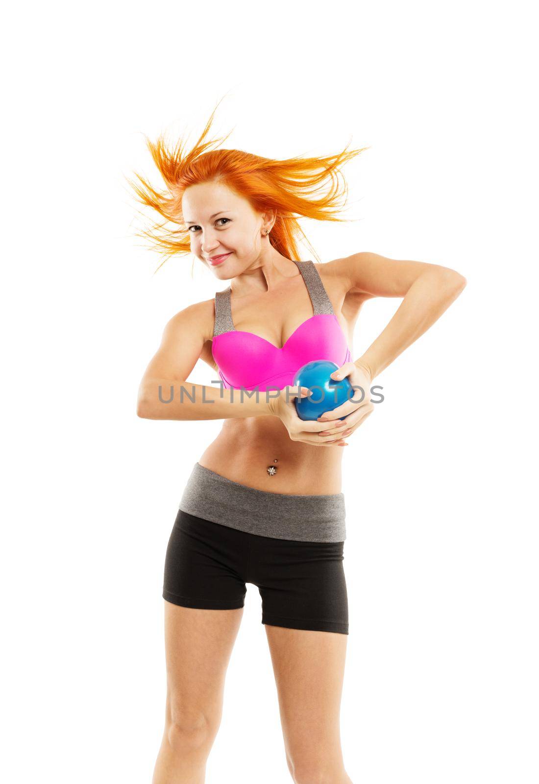 Young slim sensual red woman wearing sports bra practicing fitness