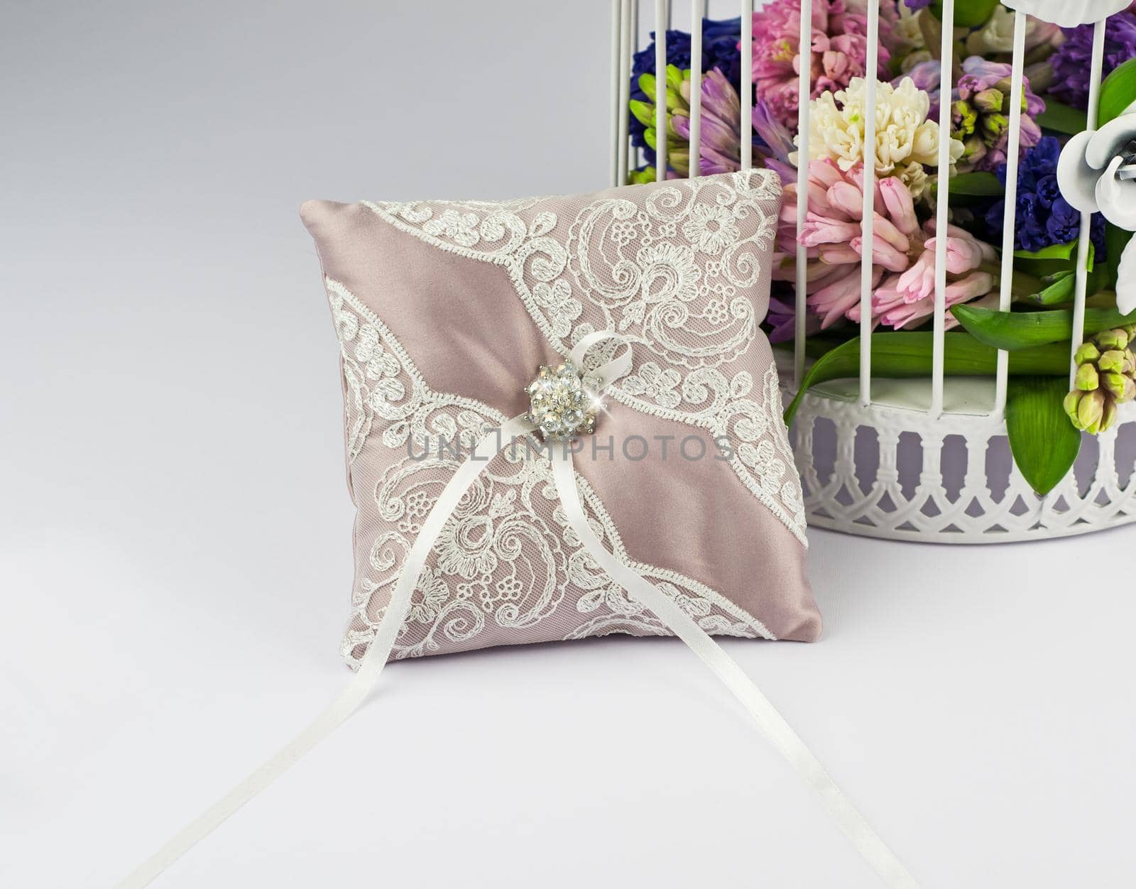 Exquisite pillow for wedding rings on gray background