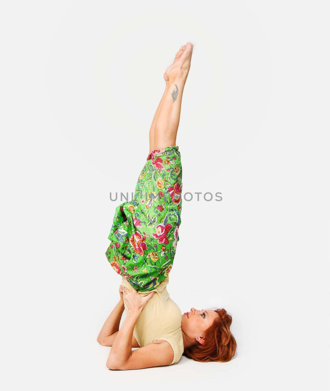 Beautiful red girl practicing yoga on white background