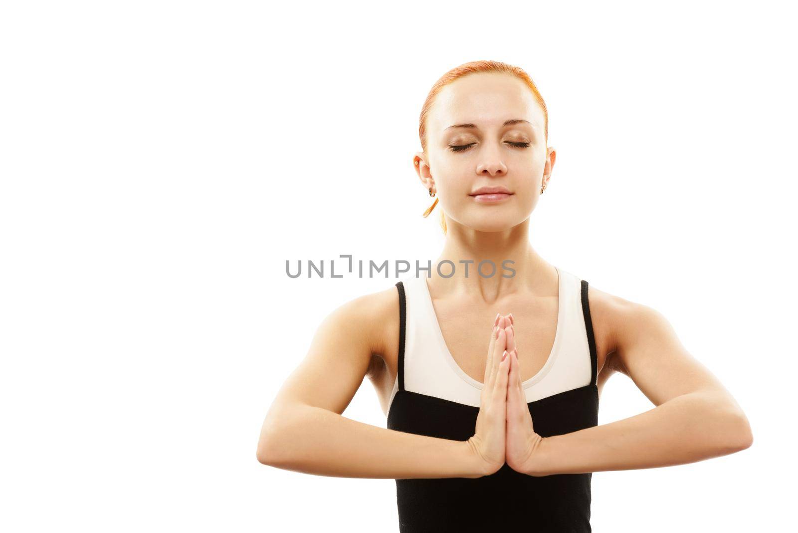Young woman in meditation pose with eyes closed over white background
